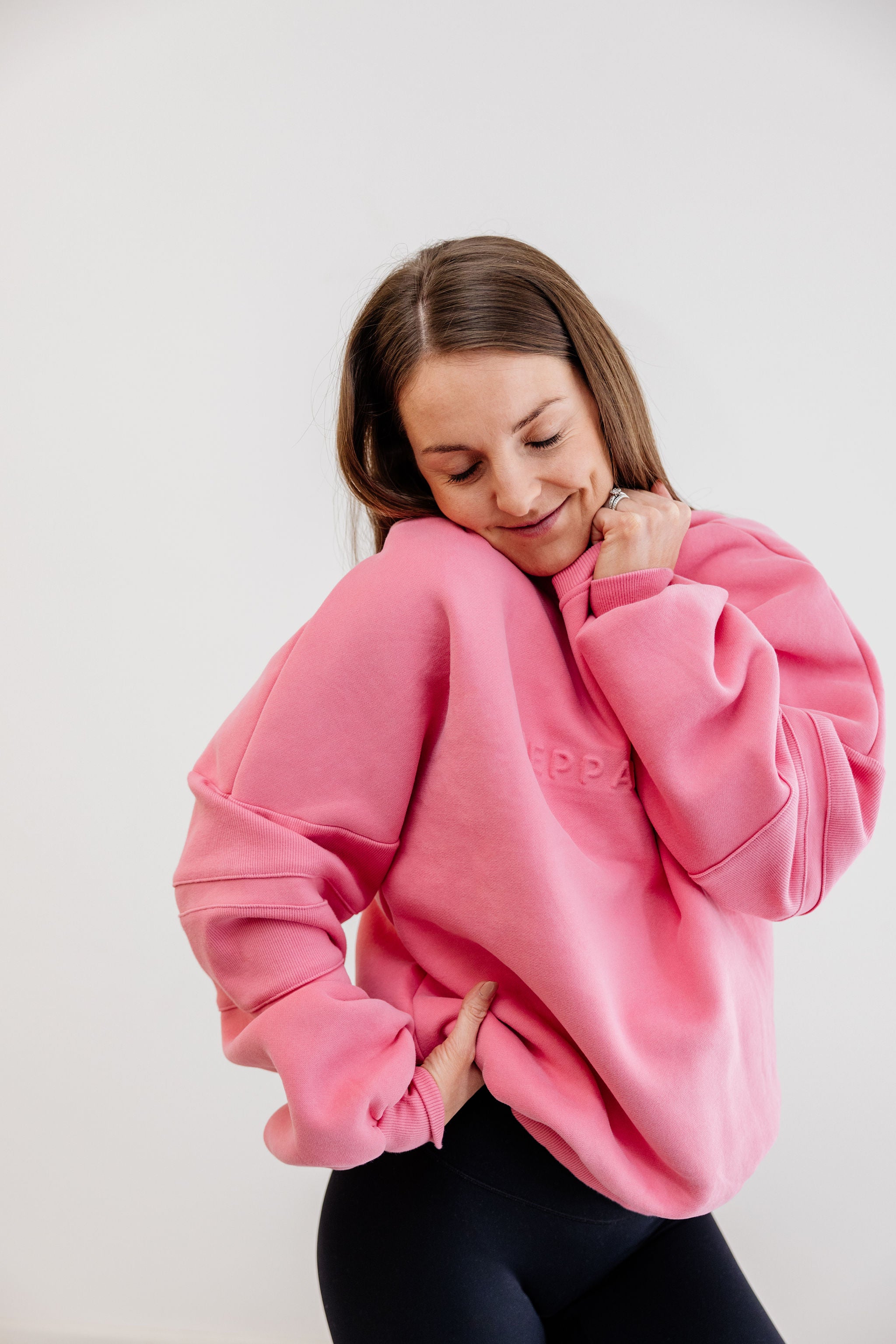 peony pink crew neck jumper with ribbed arm panels in pink with embossed logo breast cancer awareness