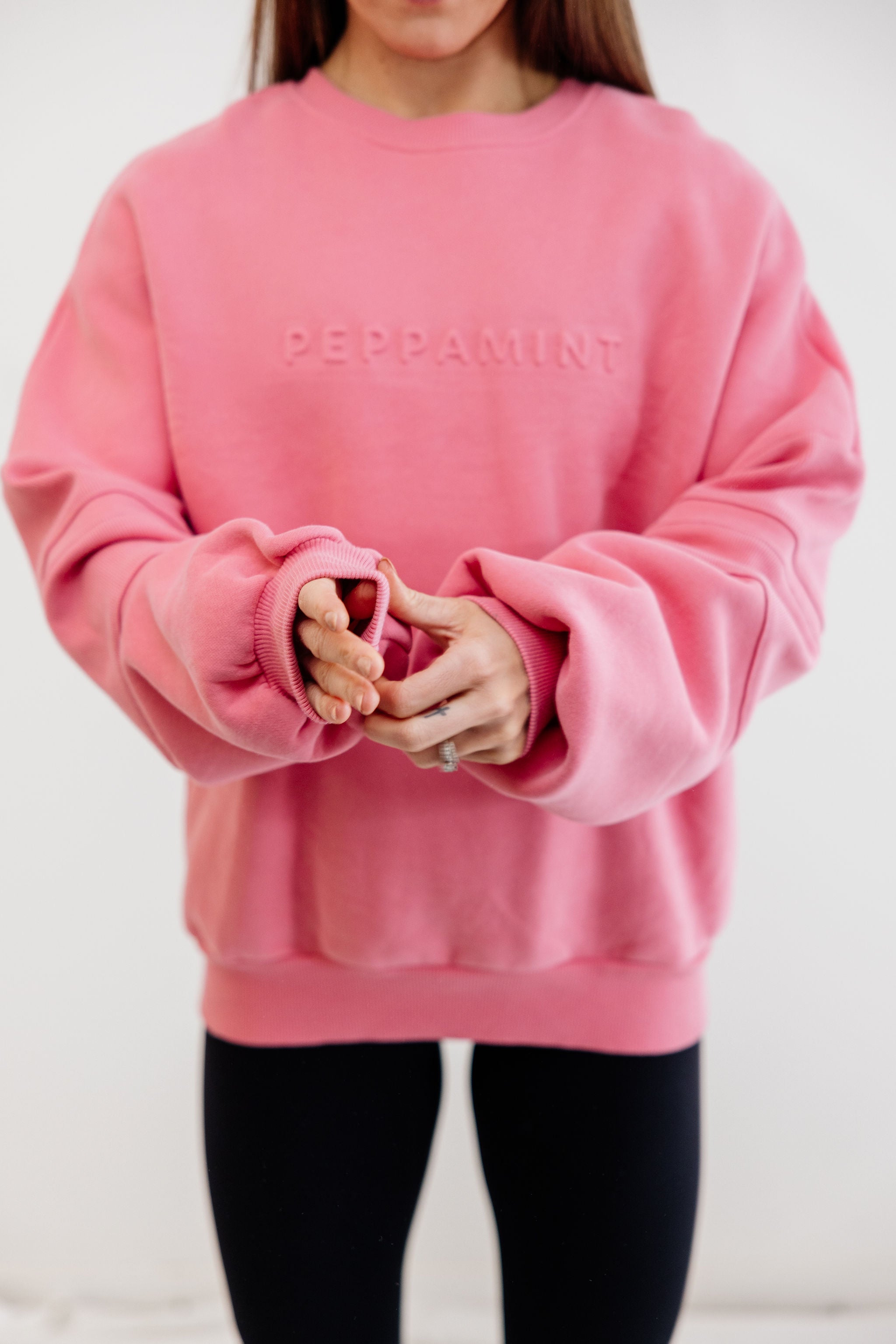 peony pink crew neck jumper with ribbed arm panels in pink with embossed logo breast cancer awareness