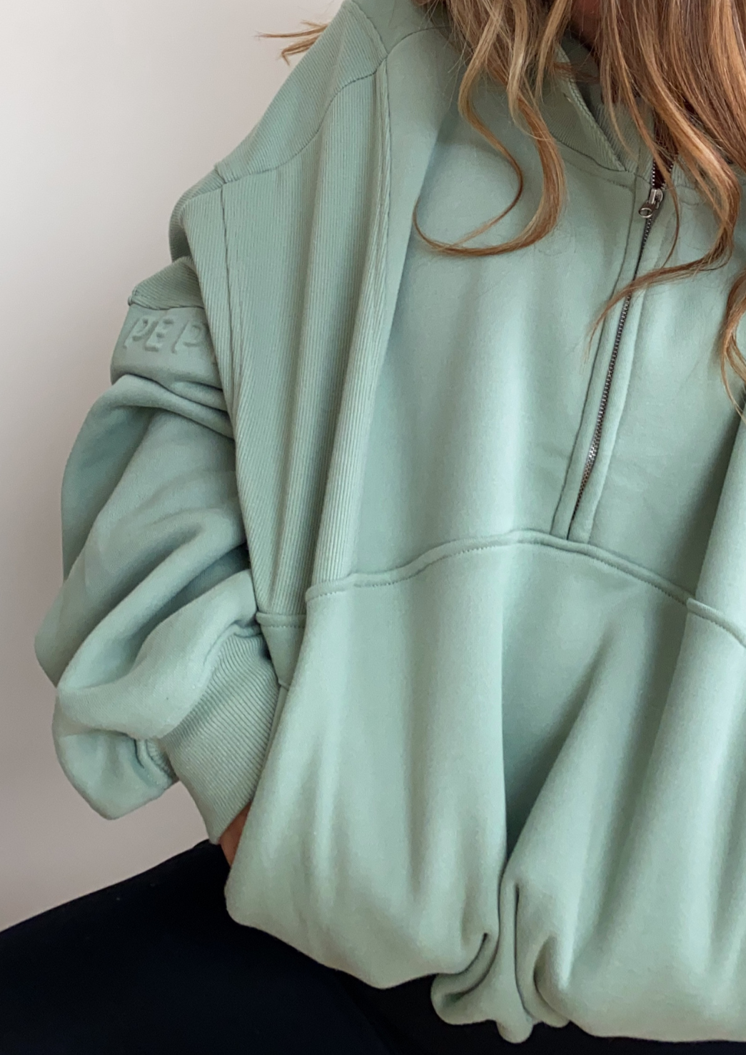 Fleece lined crop jacket in light green with half zip, and ribbed panels, and side pockets.