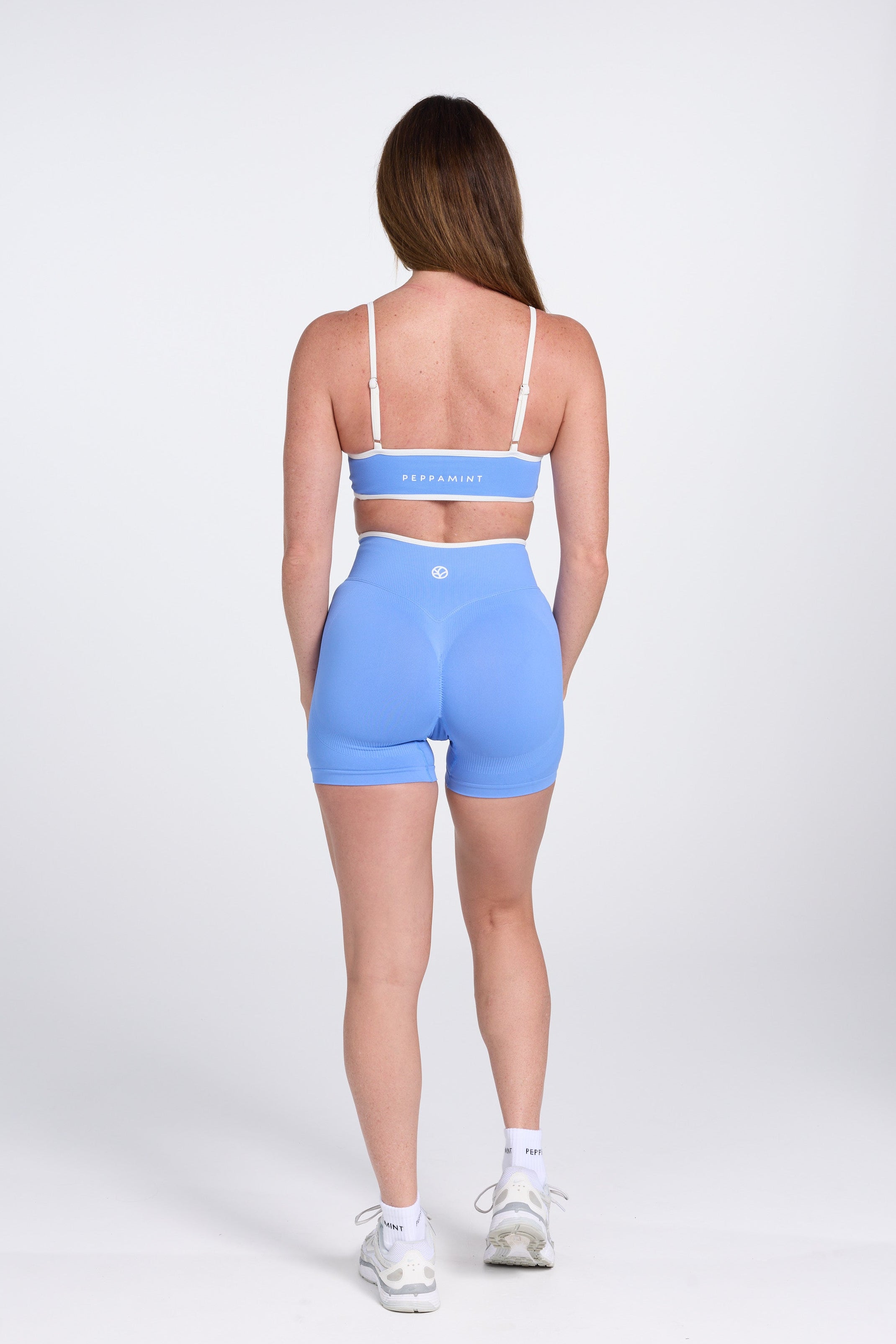 Seamless gym bra, with luxe white trim and adjustable back straps paired with high waisted booty sculpting shorts in Sky Blue.