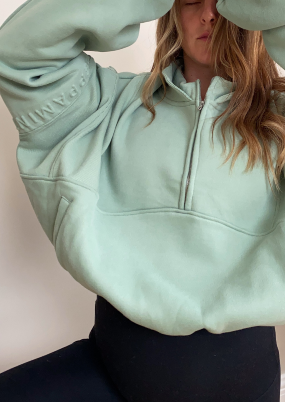 Fleece lined crop jacket in light green with half zip, and ribbed panels, and side pockets.