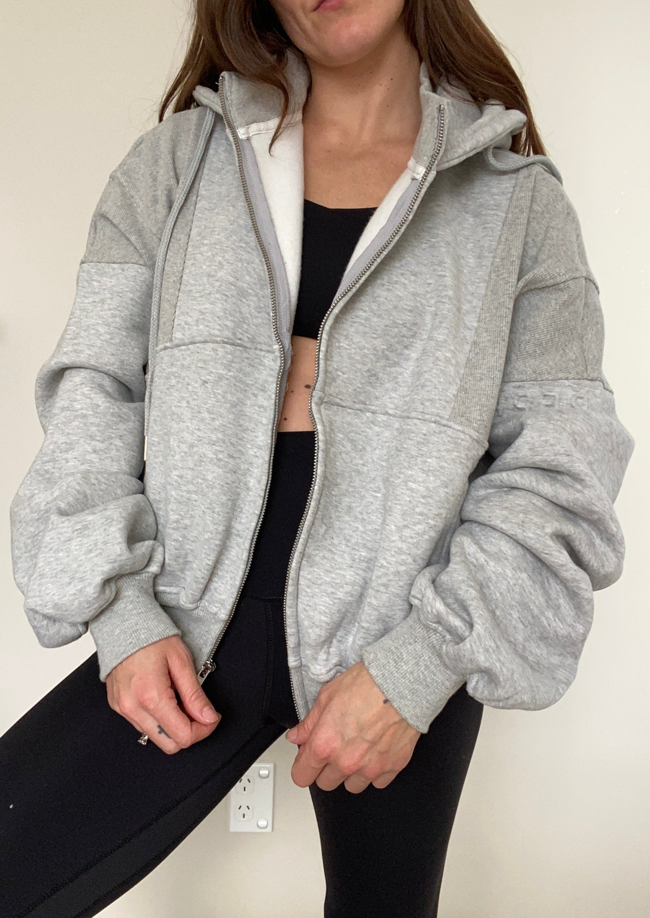Fleece lined jacket in marl grey with full zip, hood, ribbed panels, zip pockets and embossed logo's.