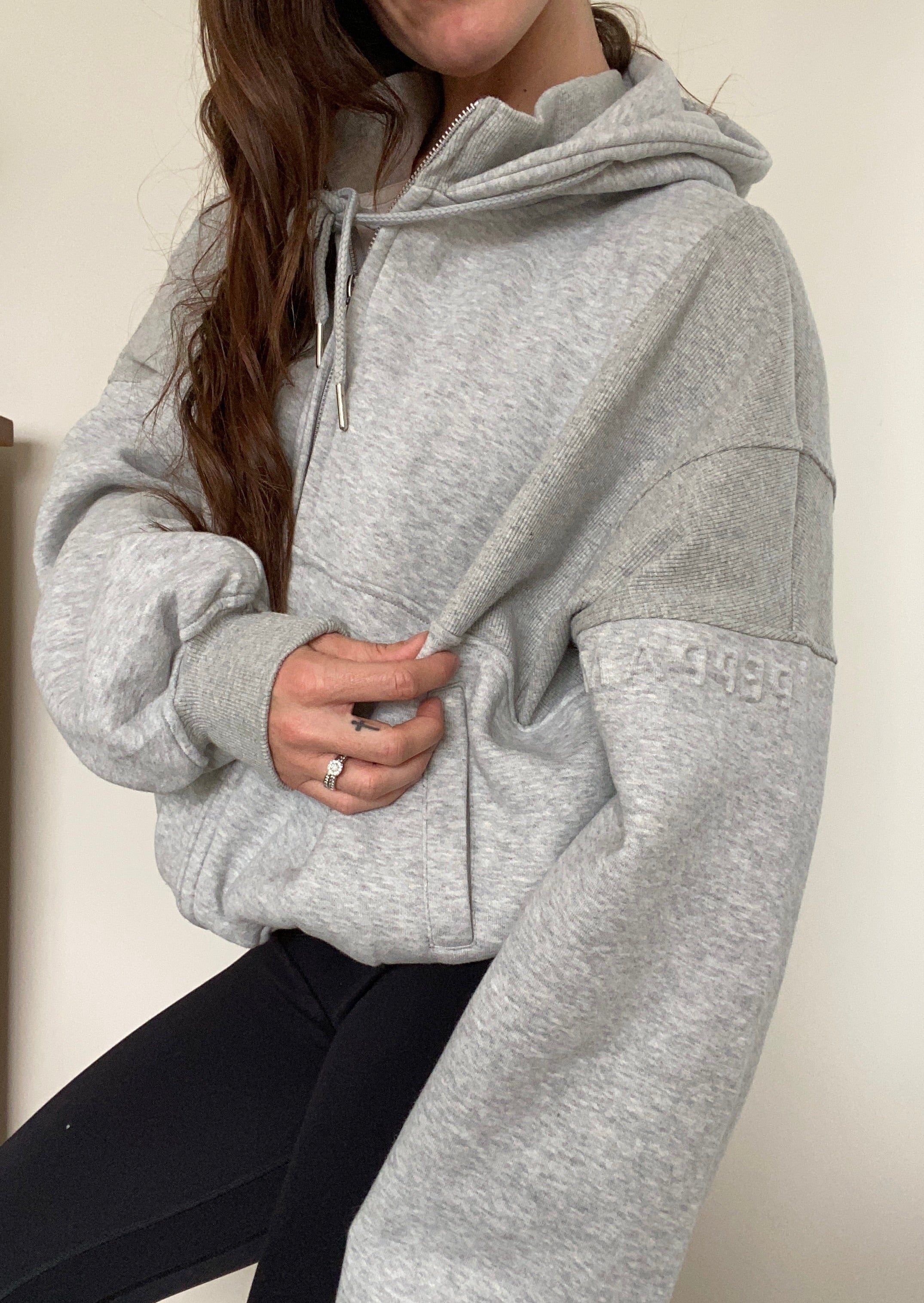 Fleece lined jacket in marl grey with full zip, hood, ribbed panels, zip pockets and embossed logo's.