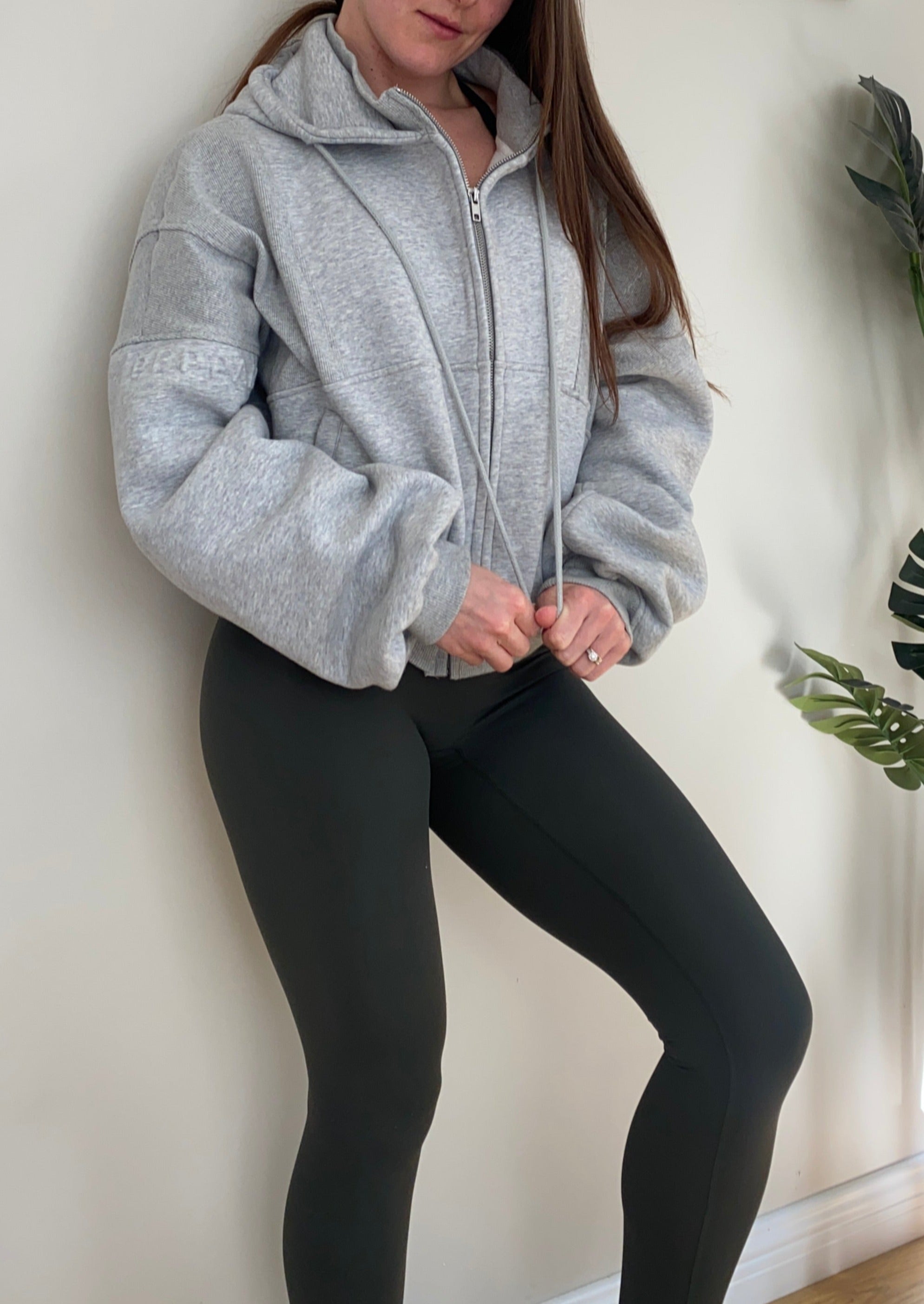 Fleece lined jacket in marl grey with full zip, hood, ribbed panels, zip pockets and embossed logo's.