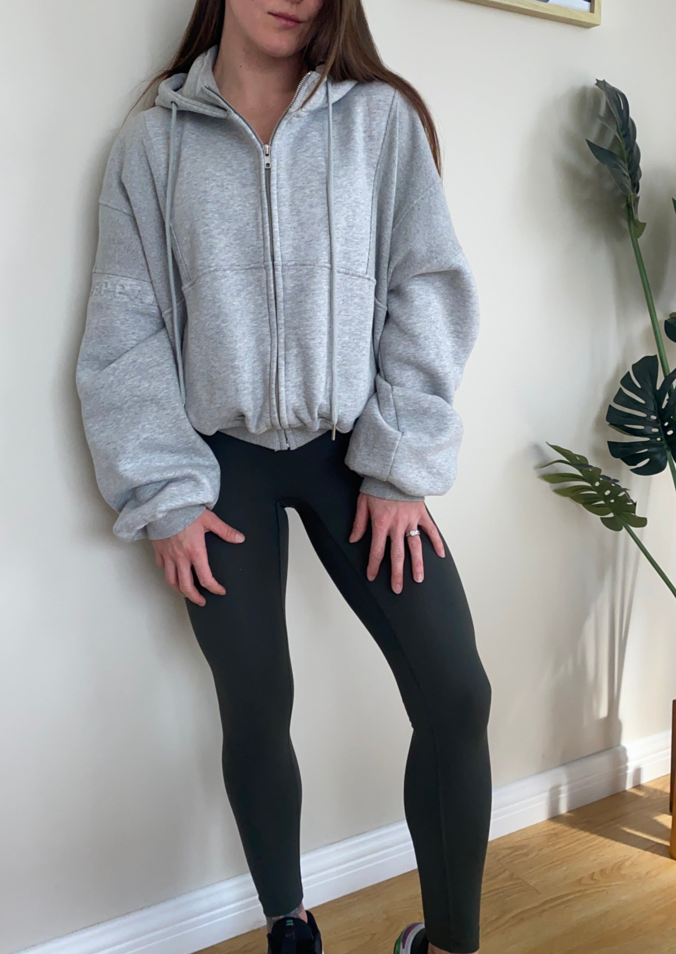 Fleece lined jacket in marl grey with full zip, hood, ribbed panels, zip pockets and embossed logo's.