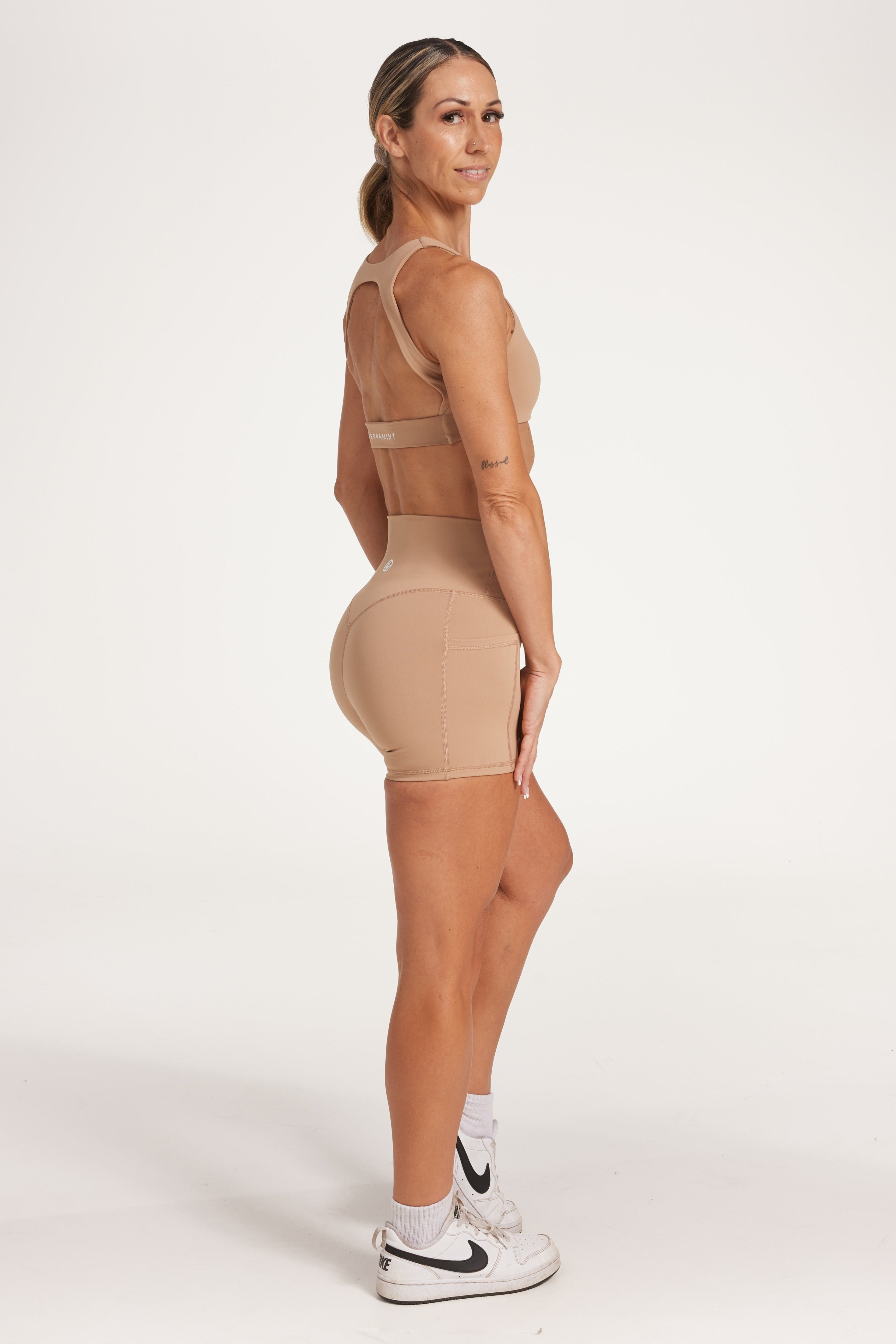 high waisted 4" inseam activewear shorts with no front rise seam, in a buttery soft, supportive fabric in light taupe colour