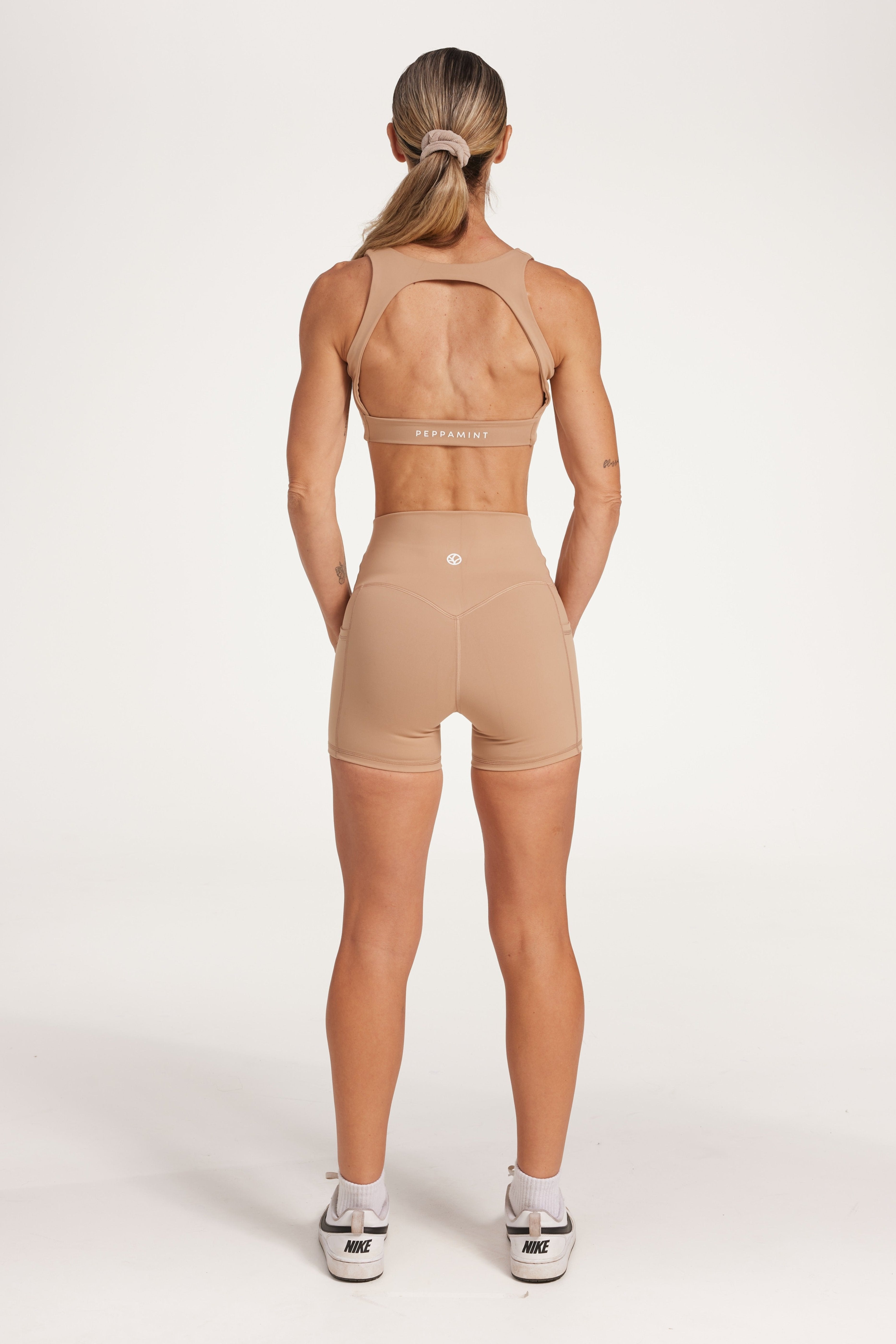 high waisted 4" inseam activewear shorts with no front rise seam, in a buttery soft, supportive fabric in light taupe colour