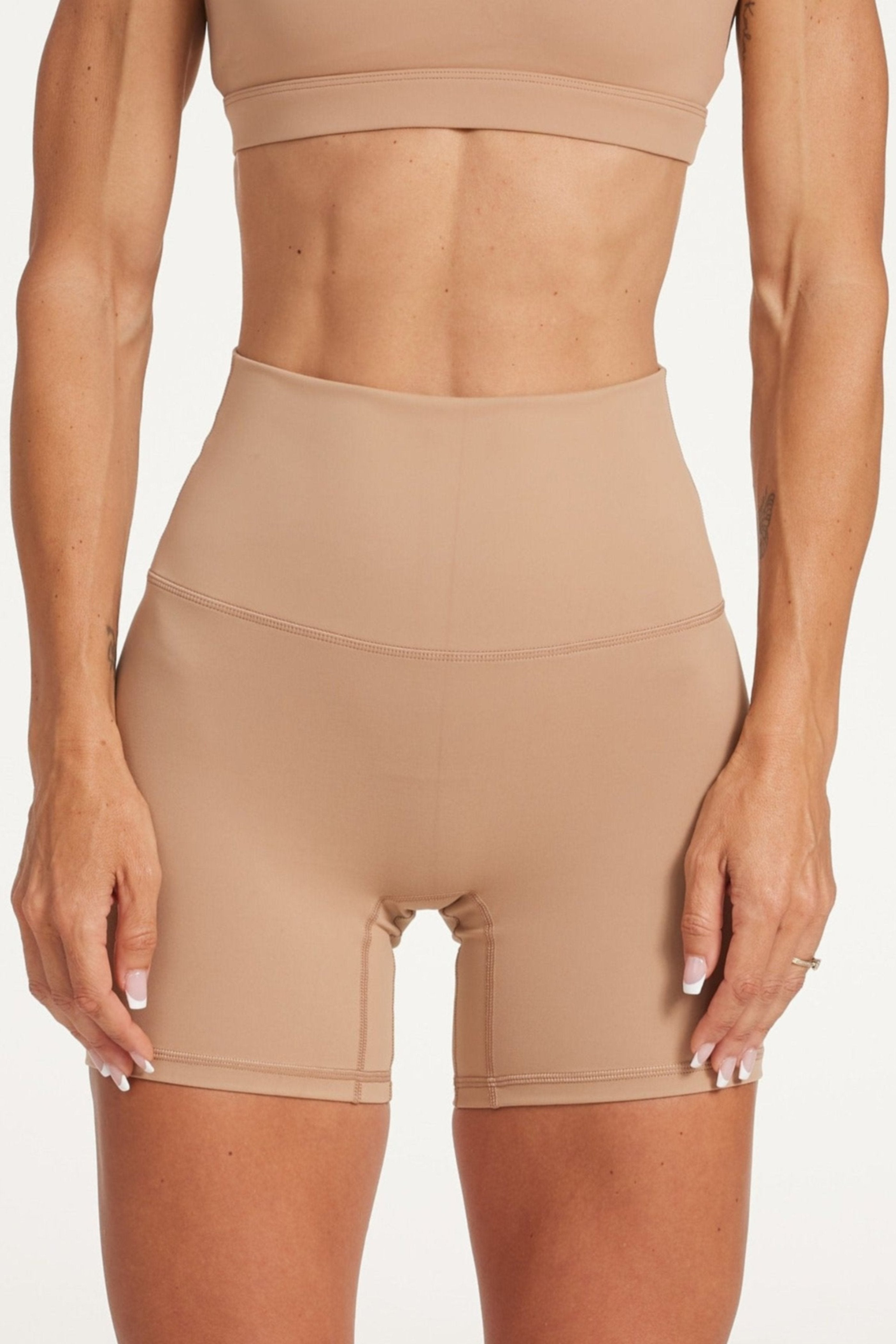 high waisted gym shorts, in buttery soft, supportive fabric with 6 inch inseam and no front rise seam, in a light taupe colour with women's moderate support activewear bra in buttery soft fabric with stunning triangle open back detail and scoop neckline