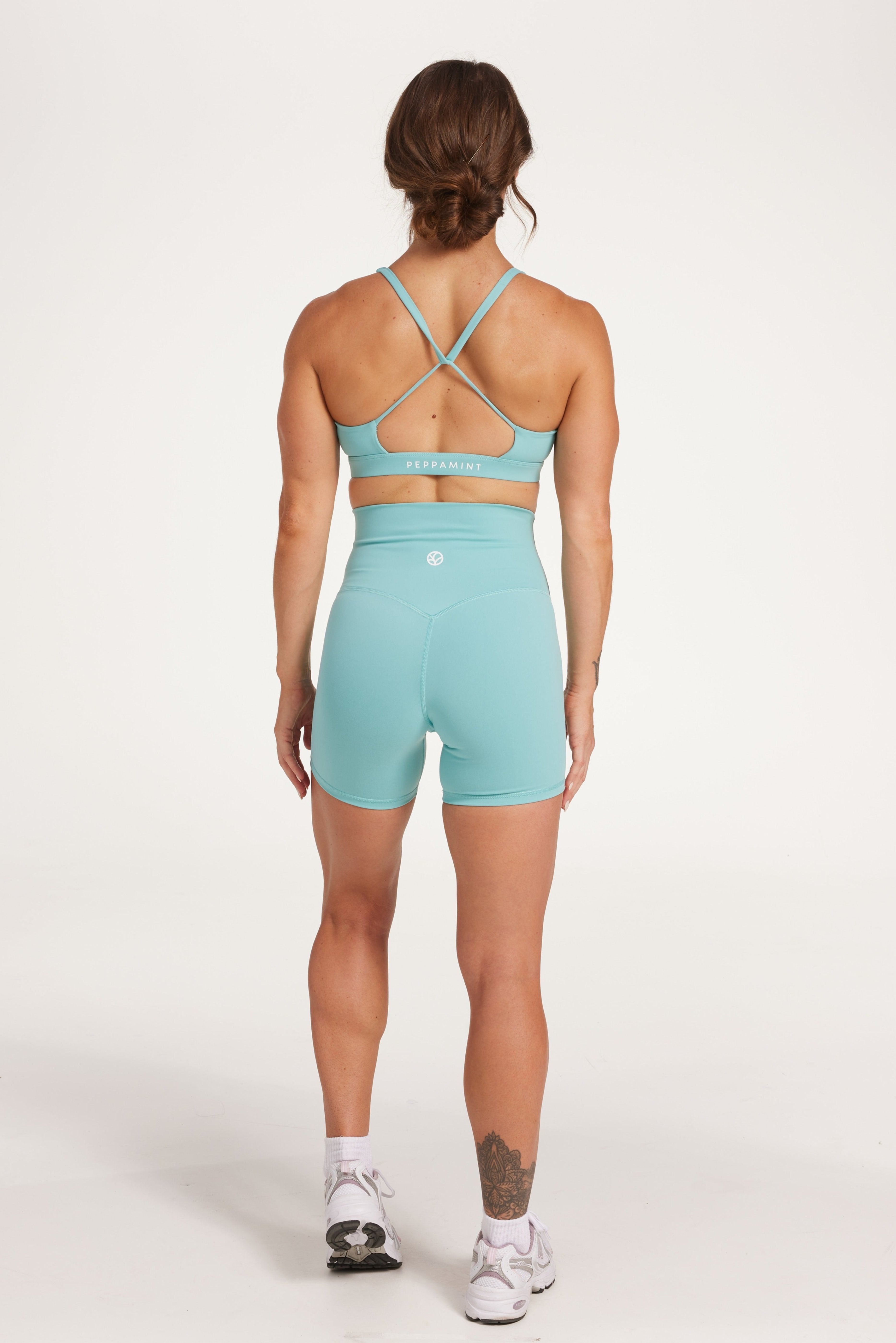 high waisted gym shorts, in buttery soft, supportive fabric with 6 inch inseam and no front rise seam, in lagoon green with women's moderate support activewear bra in buttery soft fabric with stunning triangle open back detail and scoop neckline