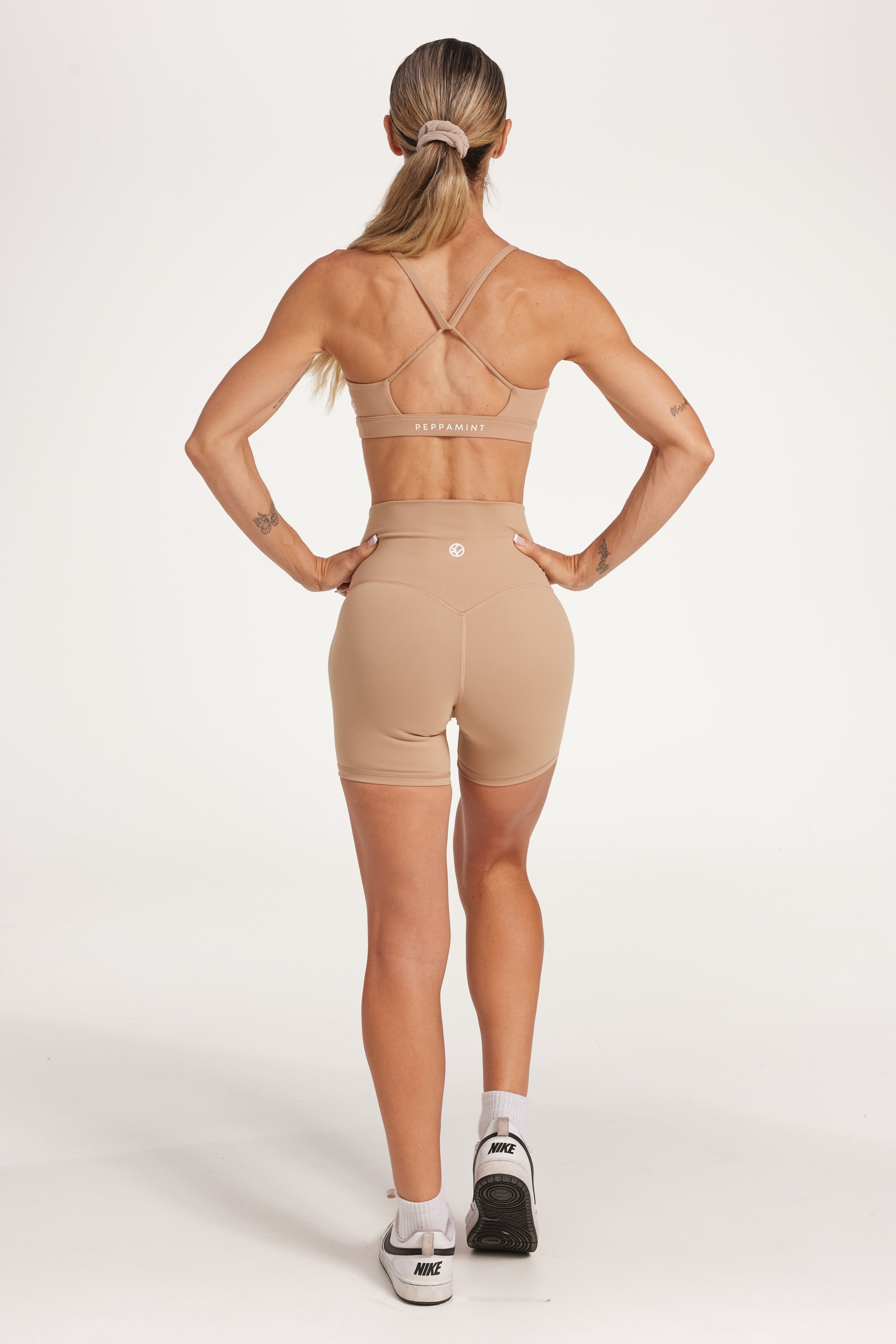 high waisted gym shorts, in buttery soft, supportive fabric with 6 inch inseam and no front rise seam, in a light taupe colour with women's moderate support activewear bra in buttery soft fabric with stunning triangle open back detail and scoop neckline