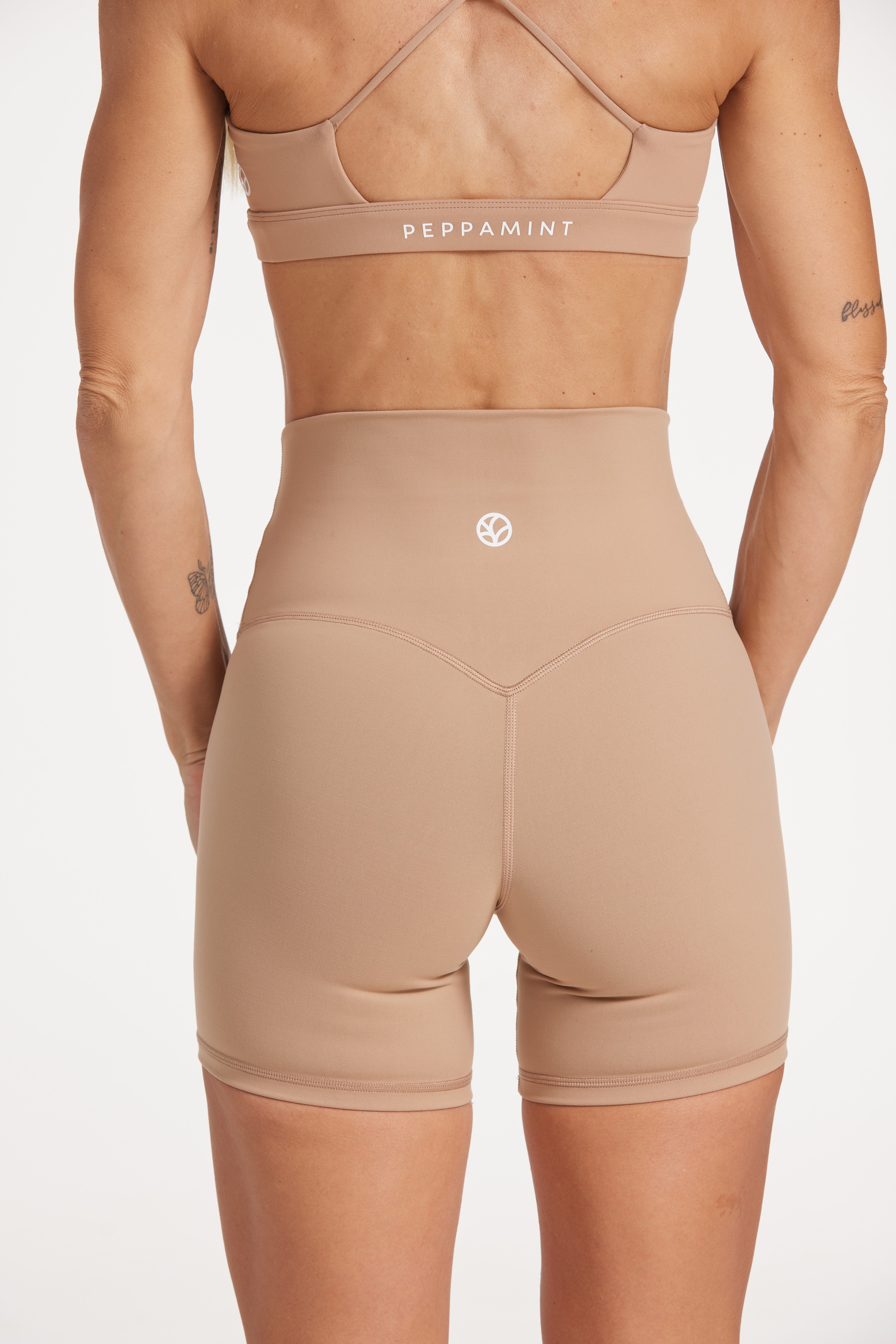 high waisted gym shorts, in buttery soft, supportive fabric with 6 inch inseam and no front rise seam, in a light taupe colour