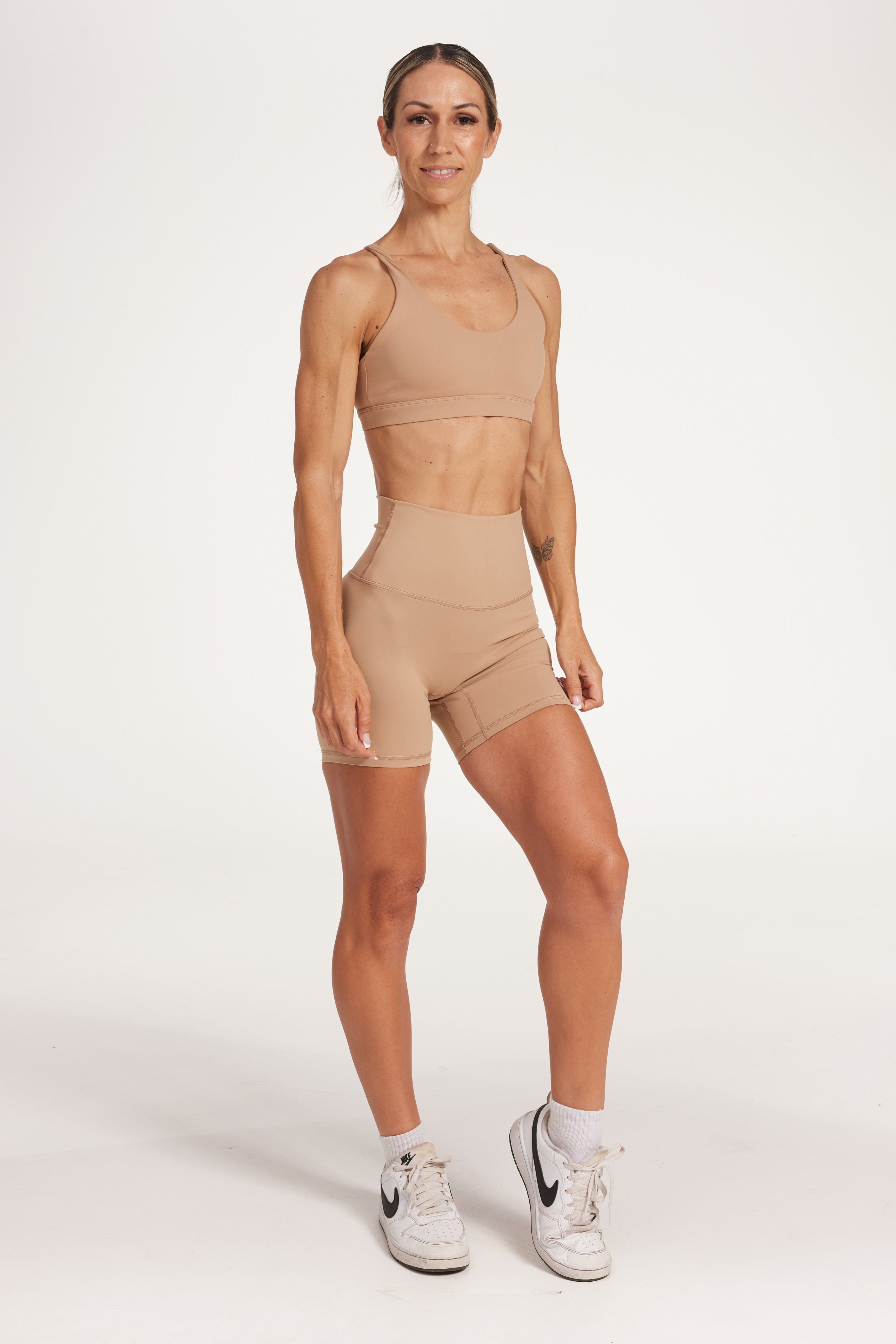 high waisted gym shorts, in buttery soft, supportive fabric with 6 inch inseam and no front rise seam, in a light taupe colour with women's moderate support activewear bra in buttery soft fabric with stunning triangle open back detail and scoop neckline