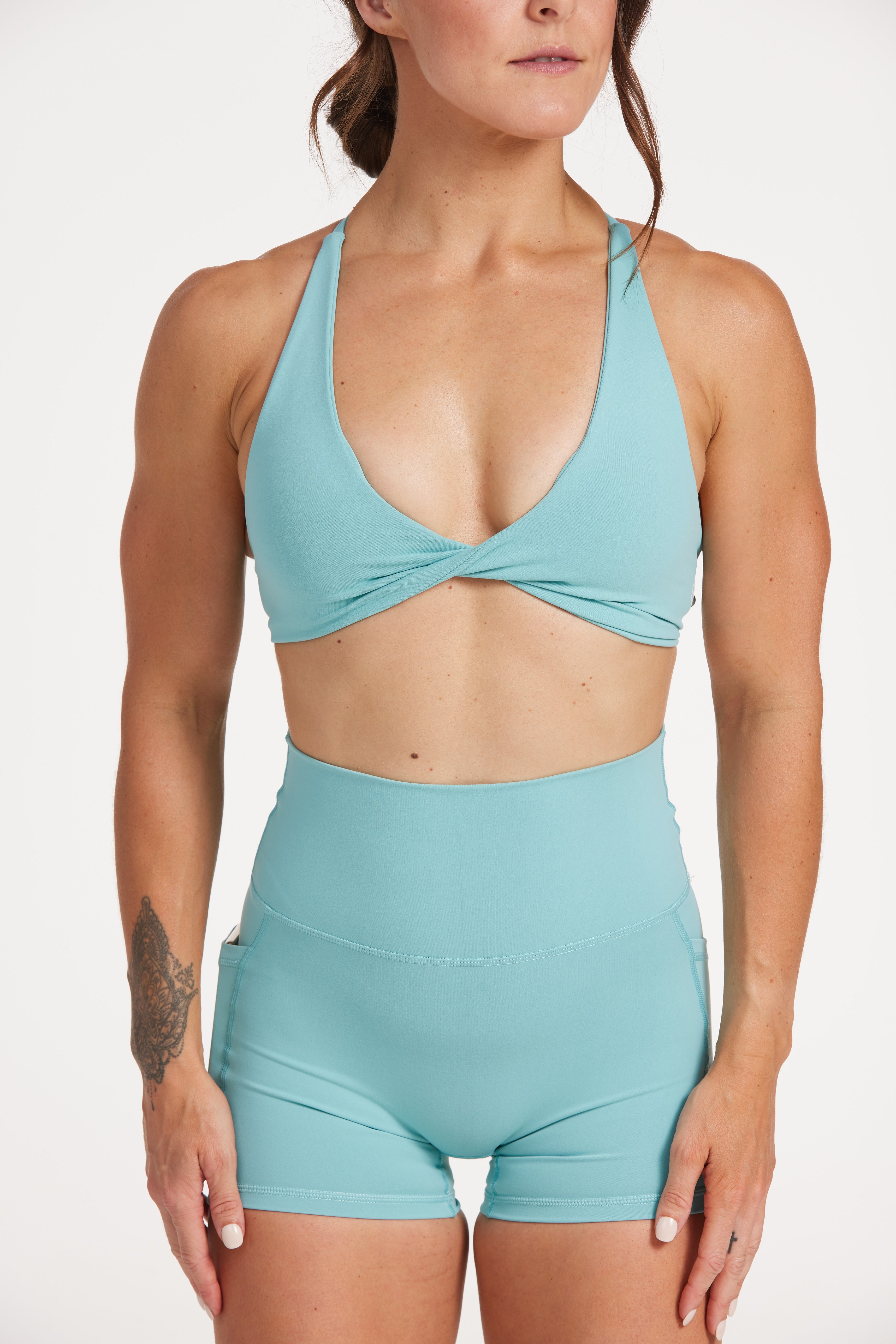twist front bra with cross over back straps in a buttery soft fabric in a lagoon green