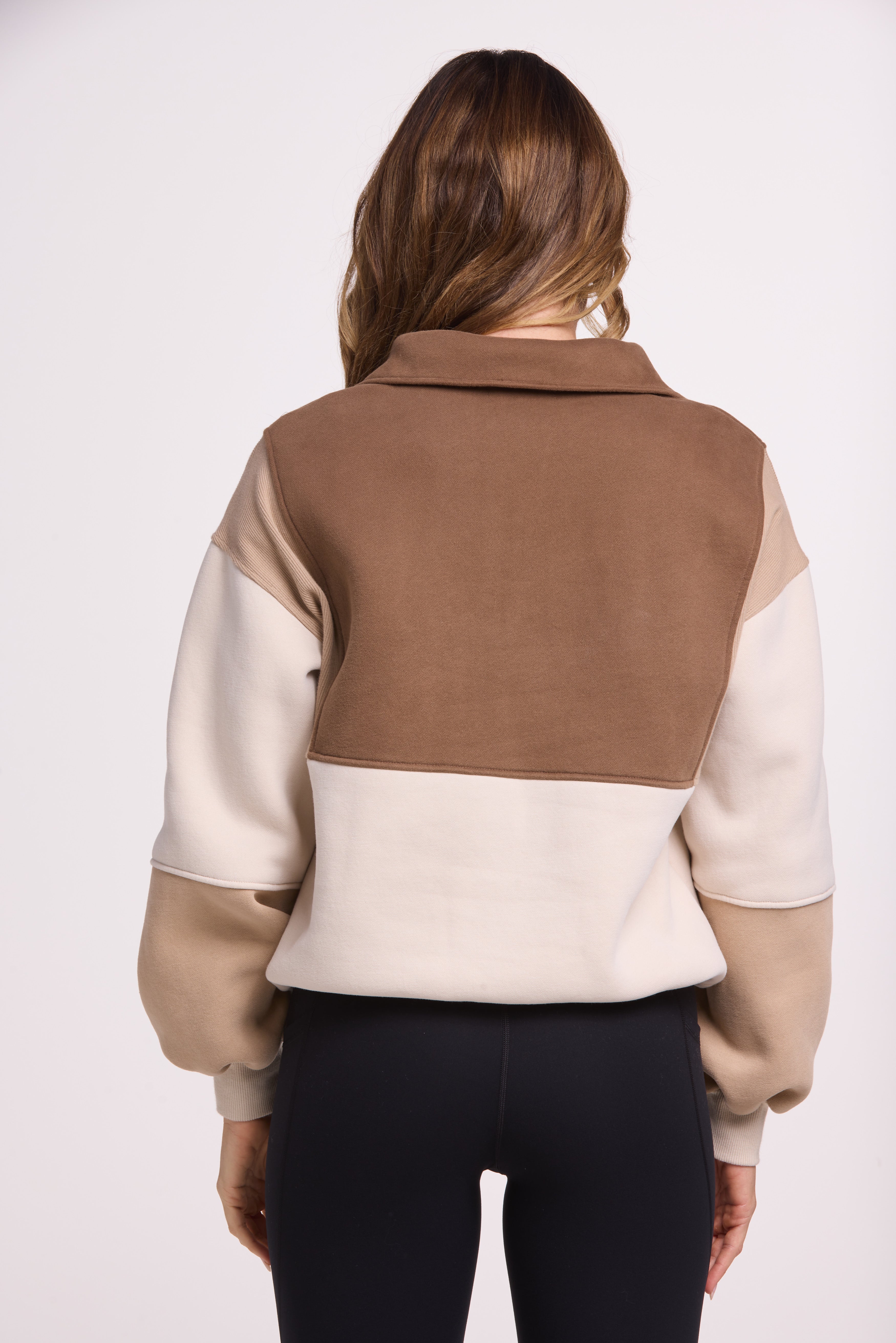 1/4 button up fleece jumper with earthy colour panels in chocolate and beige, with feature panels ribbed stretchy fabric inserts, and two convenient zip pockets.