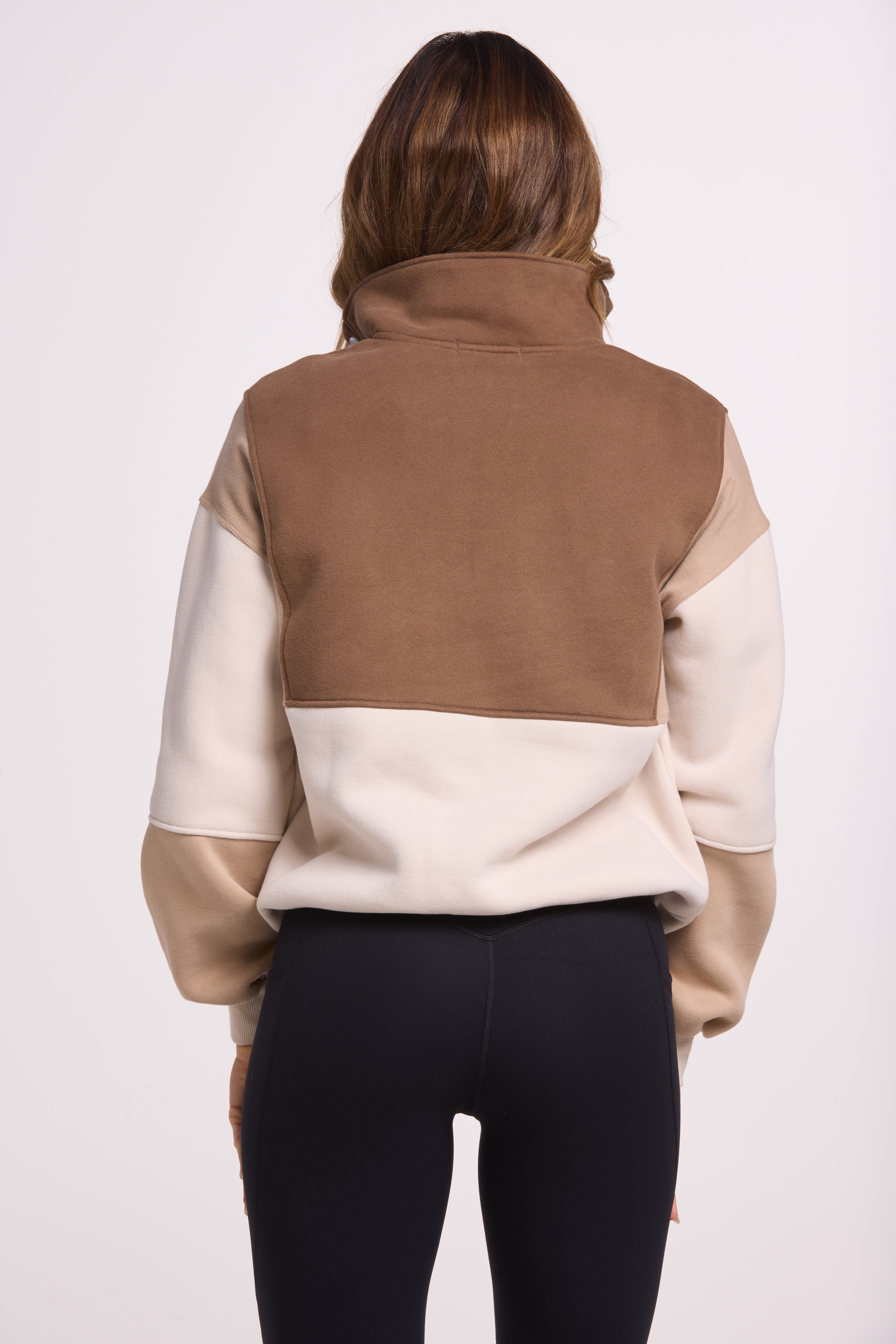1/4 button up fleece jumper with earthy colour panels in chocolate and beige, with feature panels ribbed stretchy fabric inserts, and two convenient zip pockets.