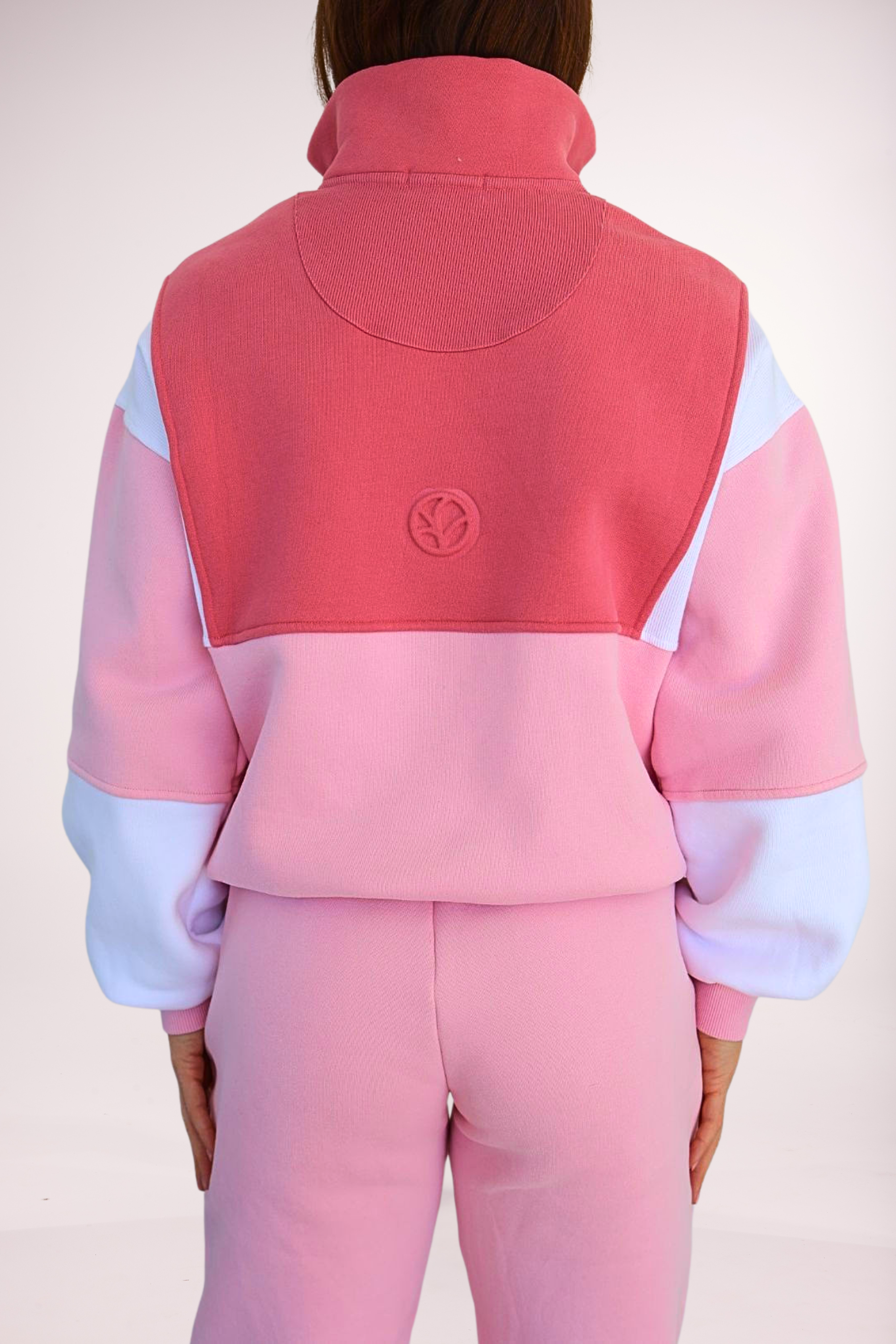 1/4 zip fleece jumper with double collar, in peony pink/white and baby pink colour panels, with feature panels ribbed stretchy fabric inserts, and two convenient zip pockets paired with fleece lined joggers with elasticated waistband, drawstring and embossed logo icon on pocket