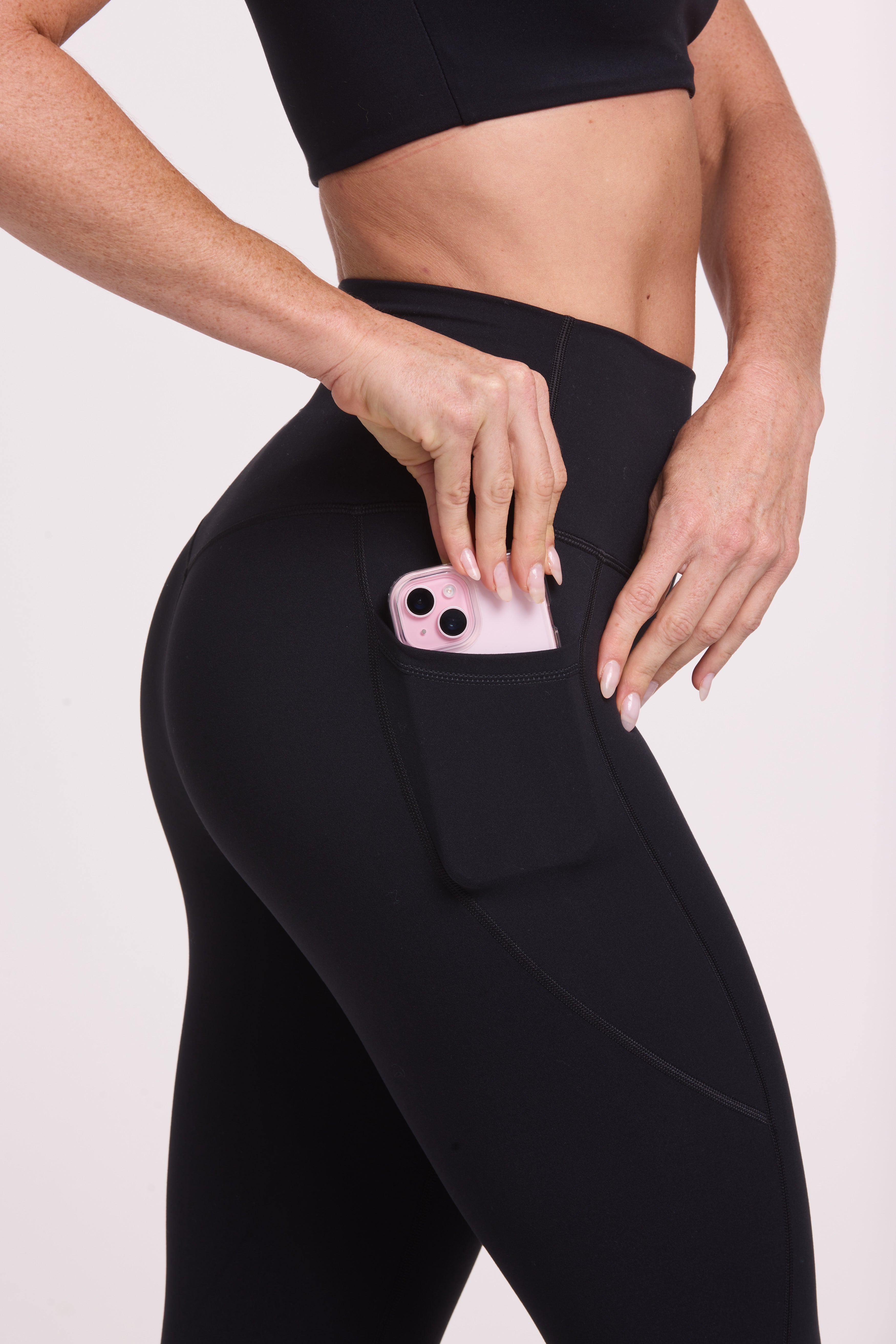 Buttery soft high waisted women's gym tights with practical pockets, sweetheart back seams for an upper glute shaping effect, and no front rise seam, paired with an V neck women's crop t-shirt with a supportive elasticated hem and triple layered fabric with removable pads for extra support in
black