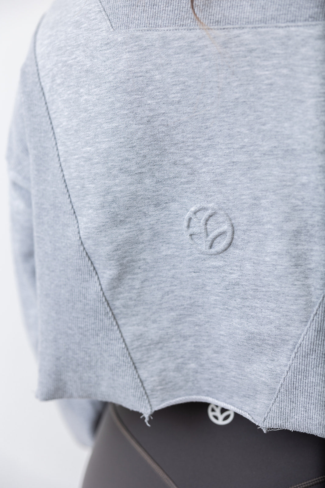 french terry cotton crop jacket with ribbed panels, raw edge hem and iconic embossed logo with half zip