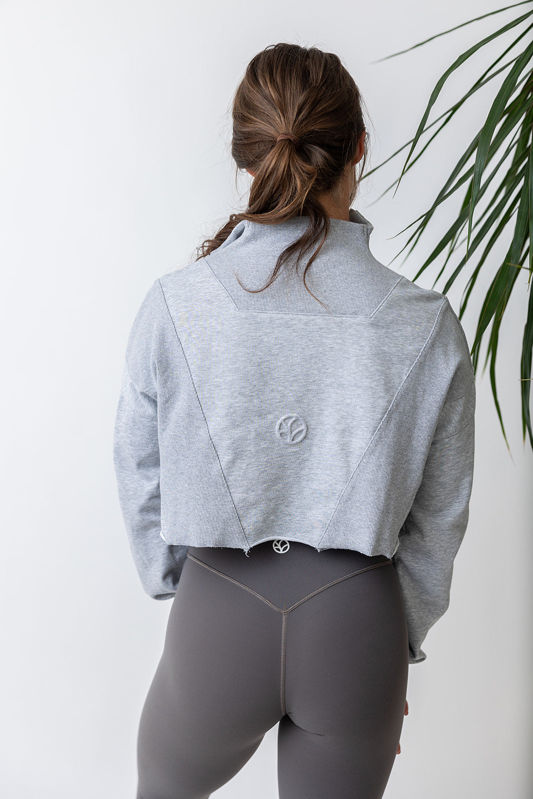 french terry cotton crop jacket with ribbed panels, raw edge hem and iconic embossed logo with half zip