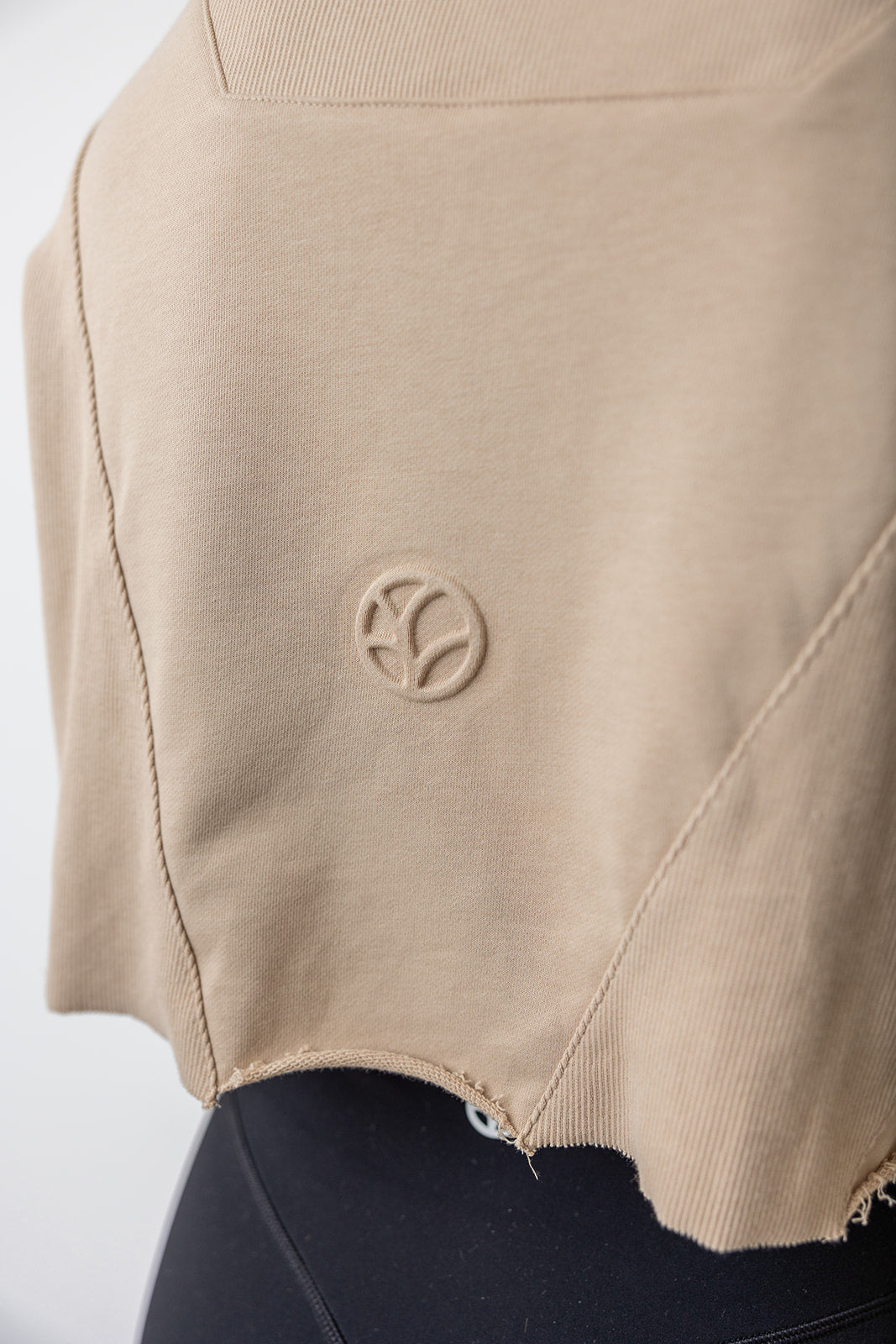 french terry cotton crop jacket with ribbed panels, raw edge hem and iconic embossed logo with half zip