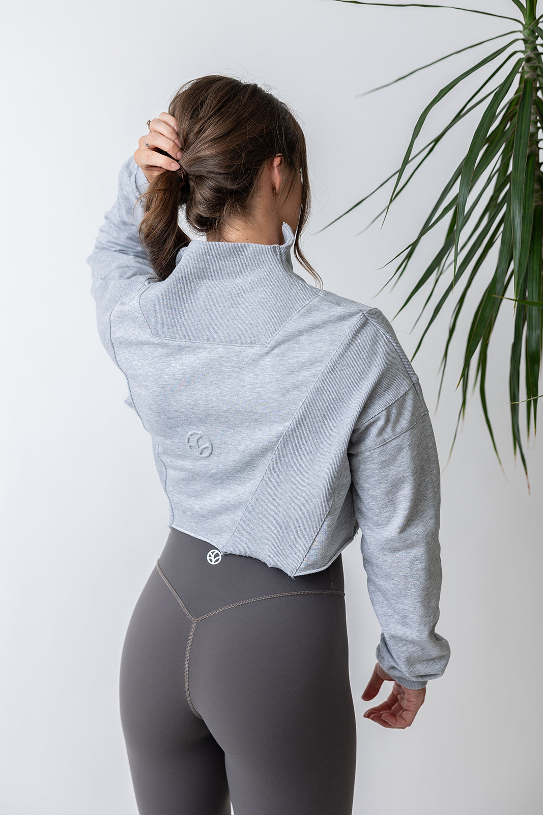 french terry cotton crop jacket with ribbed panels, raw edge hem and iconic embossed logo with half zip