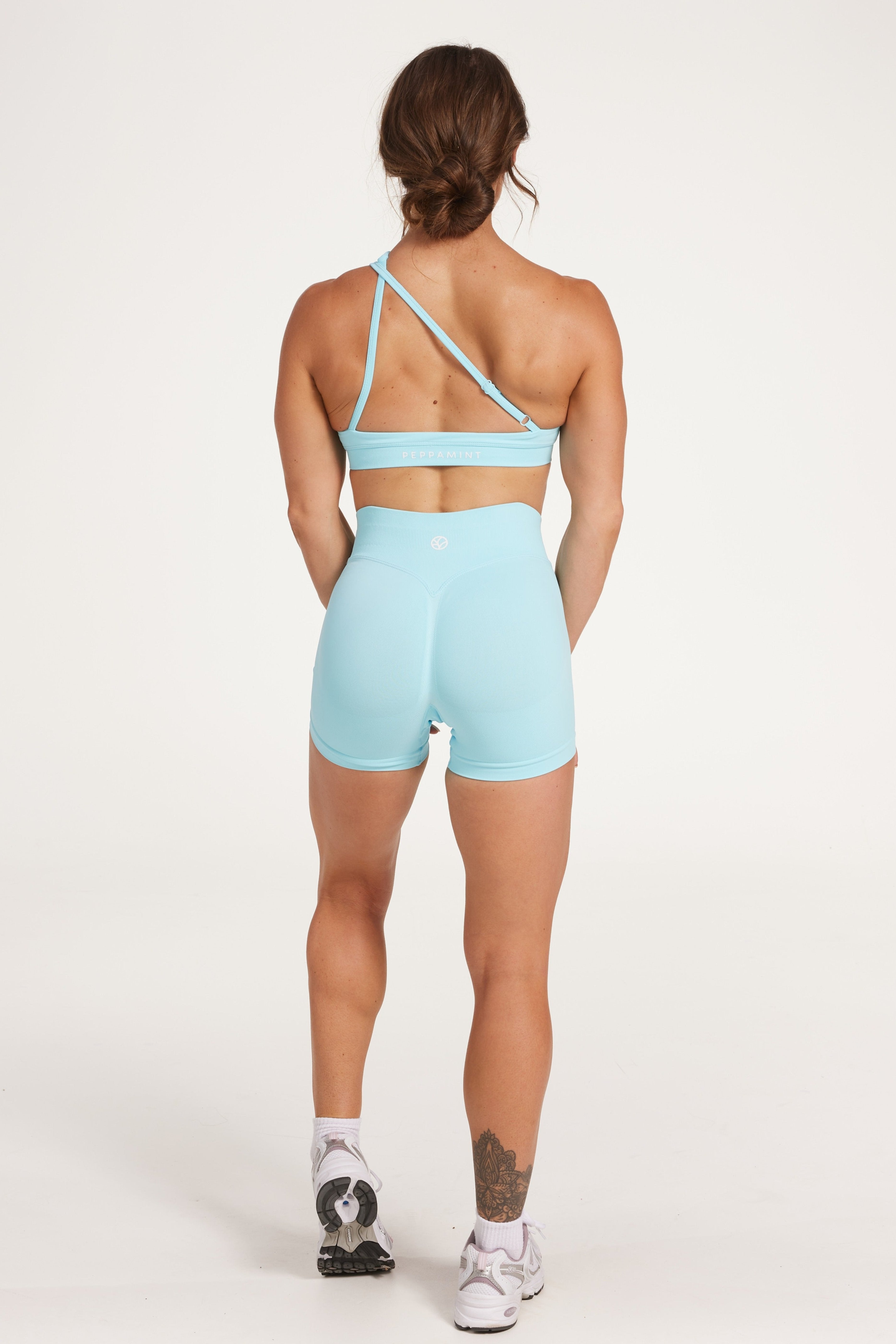 Seamless shorts with booty contouring panels, a thick supportive waistband in ice blue