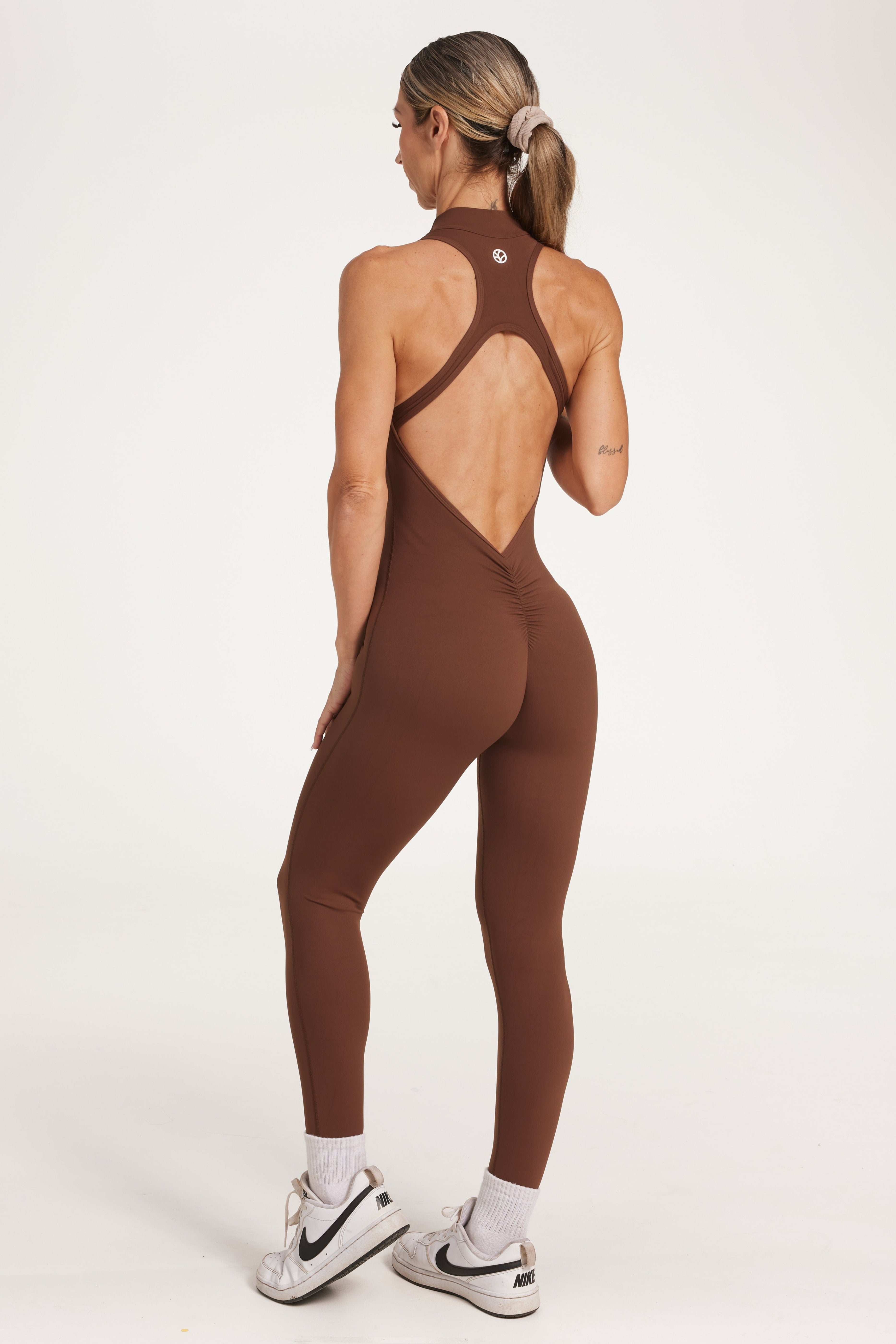 full leg length bodysuit in buttery soft fabric with half zipper, high neck design, scrunch butt, and open back detail.