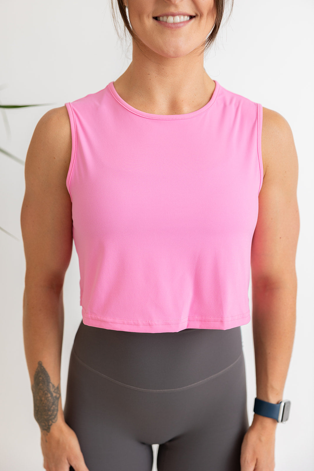 buttery soft crop length tank top in baby pink with subtle stitched logo tag