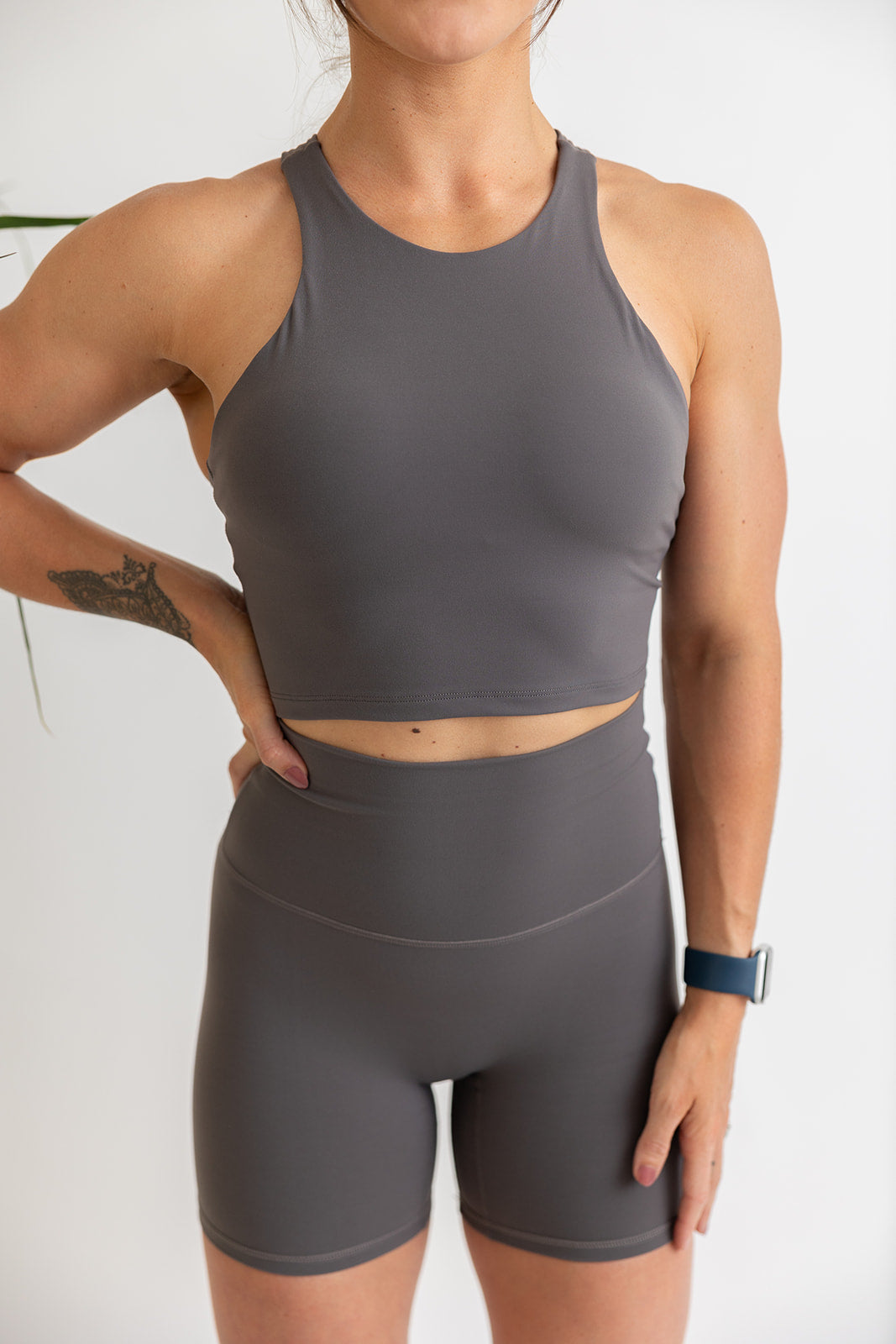 crop tank top in graphite with build in removable bra pads, racerback design and subtle stitched logo tag