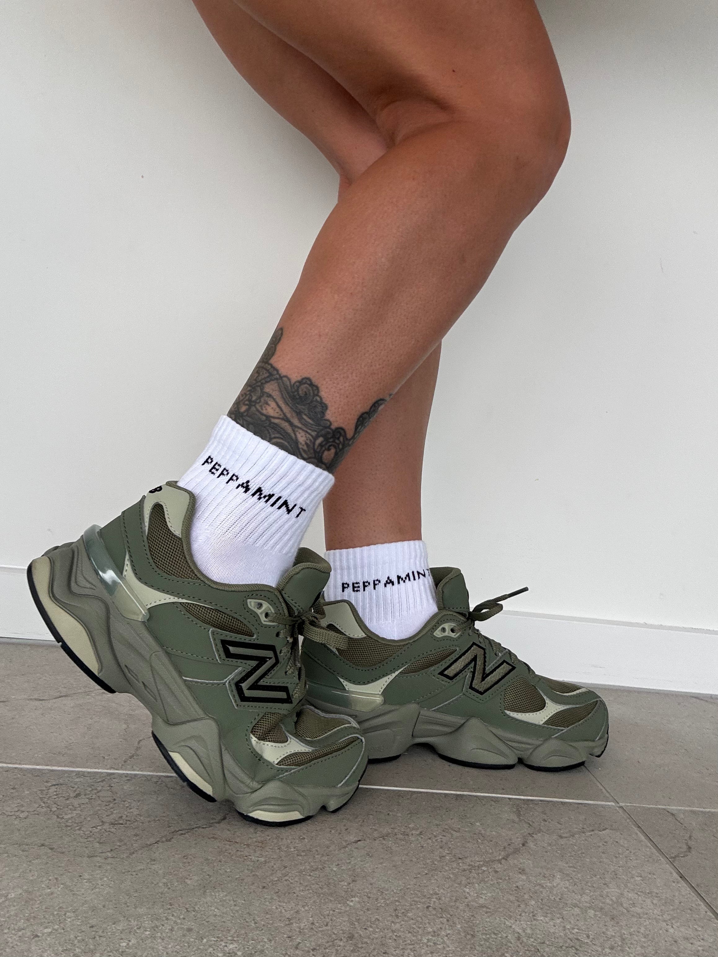 Thick. durable 1/4 socks with comfortable padded footbed, ribbed upper and stitched black PEPPAMINT logo placed horizontal on upper sock