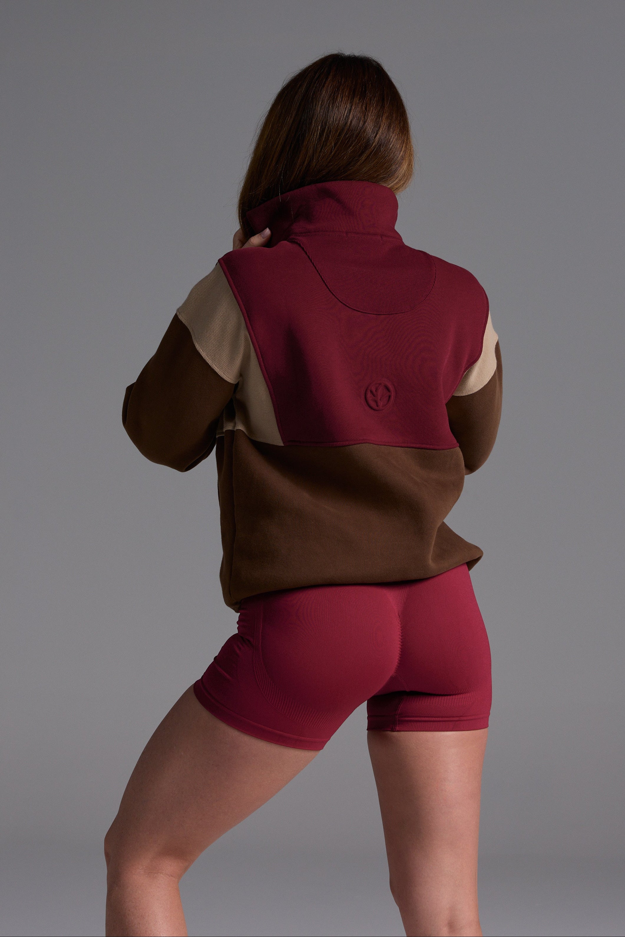 1/4 zip fleece jumper with double collar, ribbed stretchy fabric panel inserts, and two convenient zip pockets in a wine, chocolate and beige colour block design.