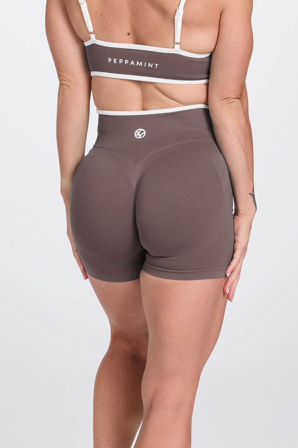 High waisted booty sculpting gym shorts, with textured contouring panels and a luxe white trim with PEPPAMINT branded down the upper thigh, in Mocha colour.