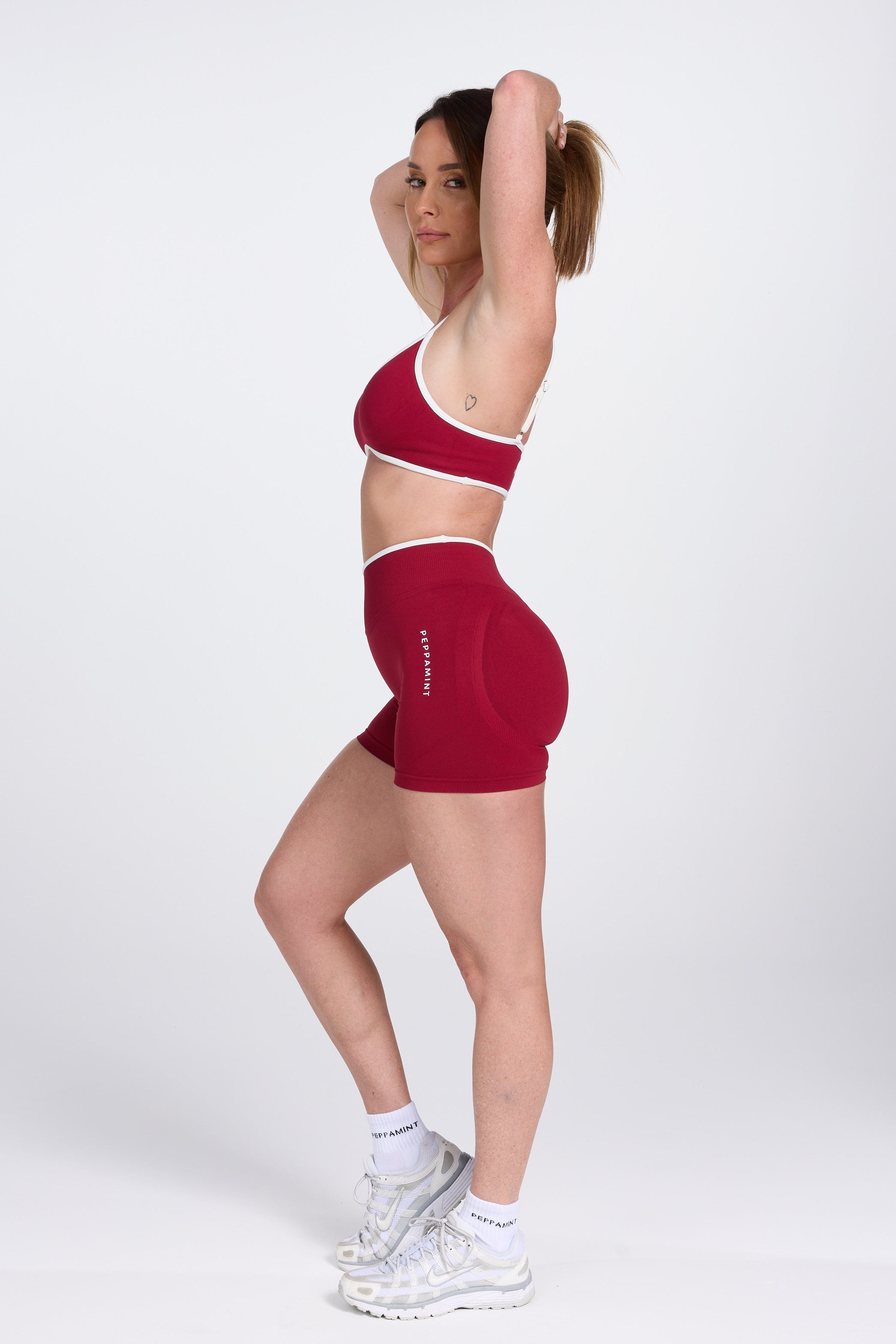 Seamless gym bra, with luxe white trim and adjustable back straps in wine colour.