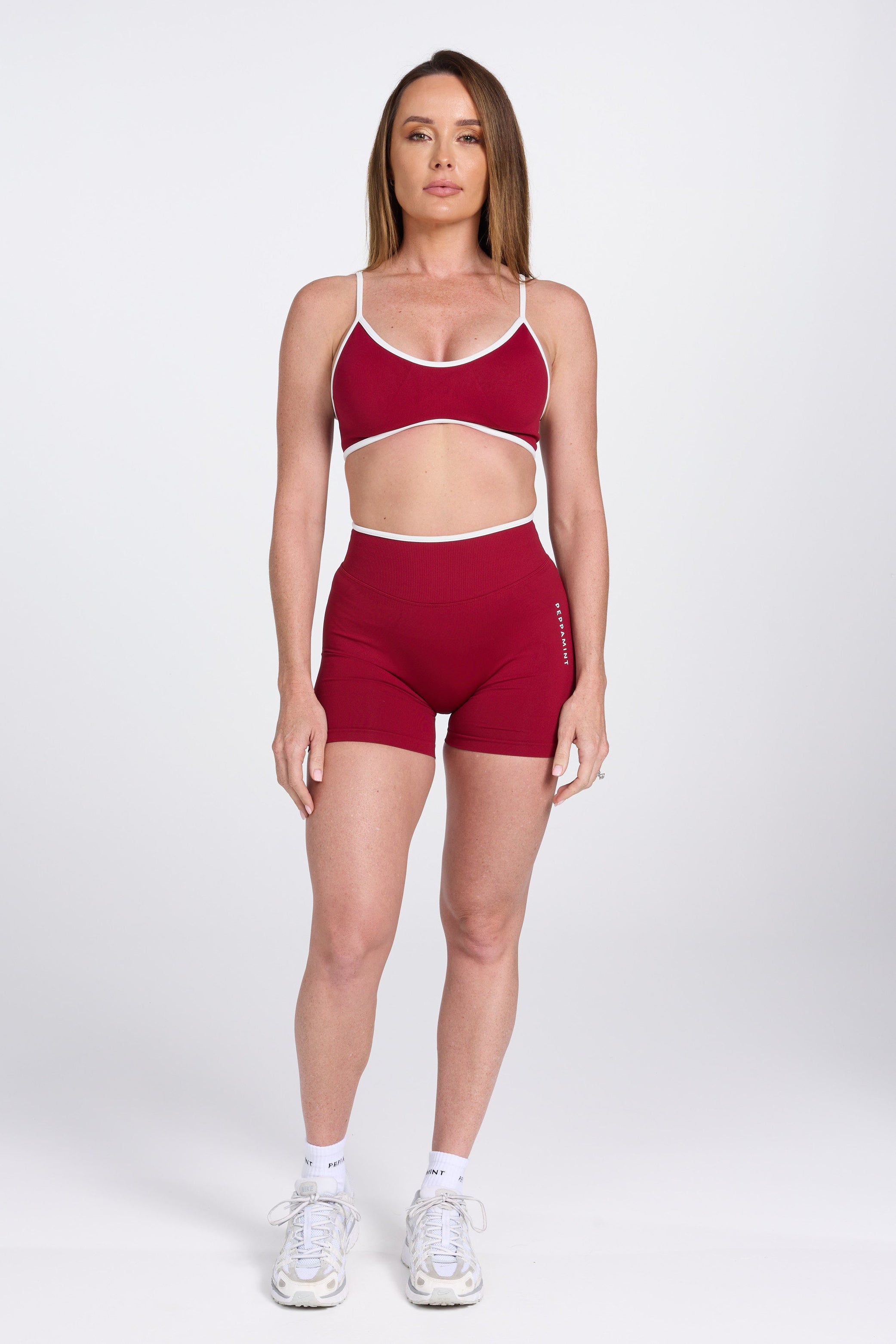 Seamless gym bra, with luxe white trim and adjustable back straps in wine colour.