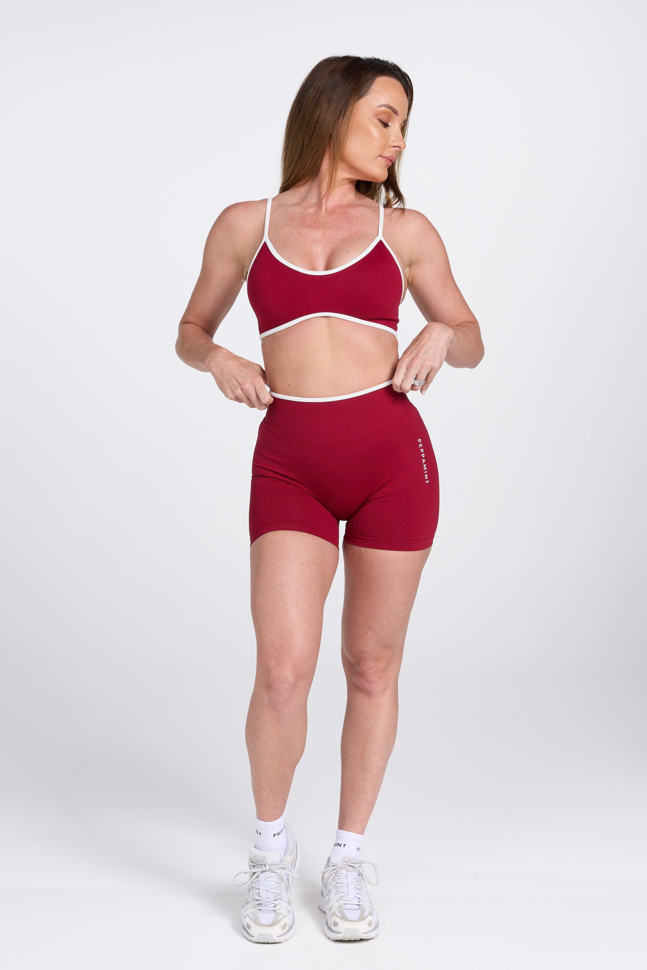 Seamless gym bra, with luxe white trim and adjustable back straps in wine colour.
