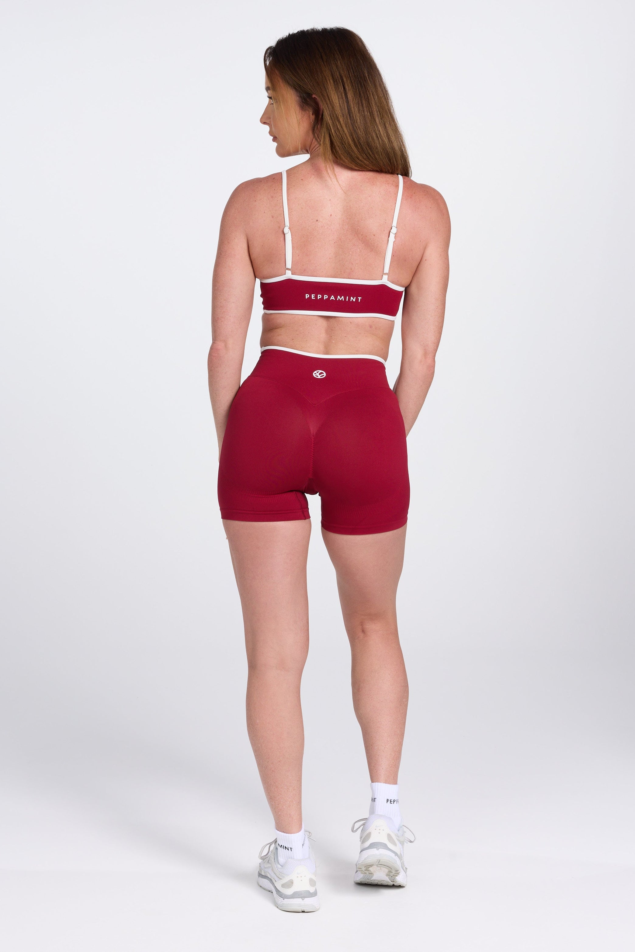 Seamless gym bra, with luxe white trim and adjustable back straps in wine colour.