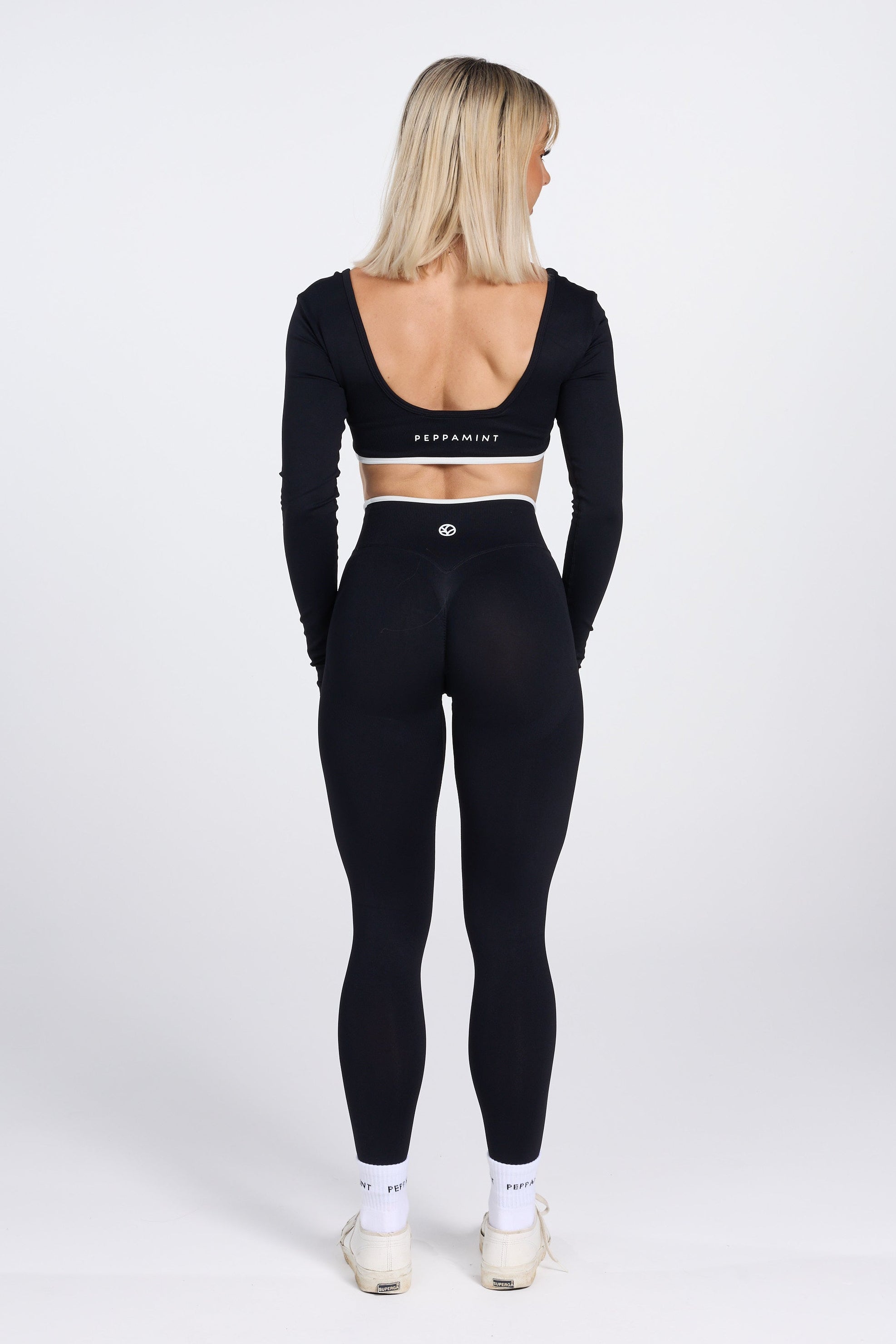 Long sleeve seamless crop top, with built in white contrasting bra, luxe white trim, and adjustable halter strap in black colour.