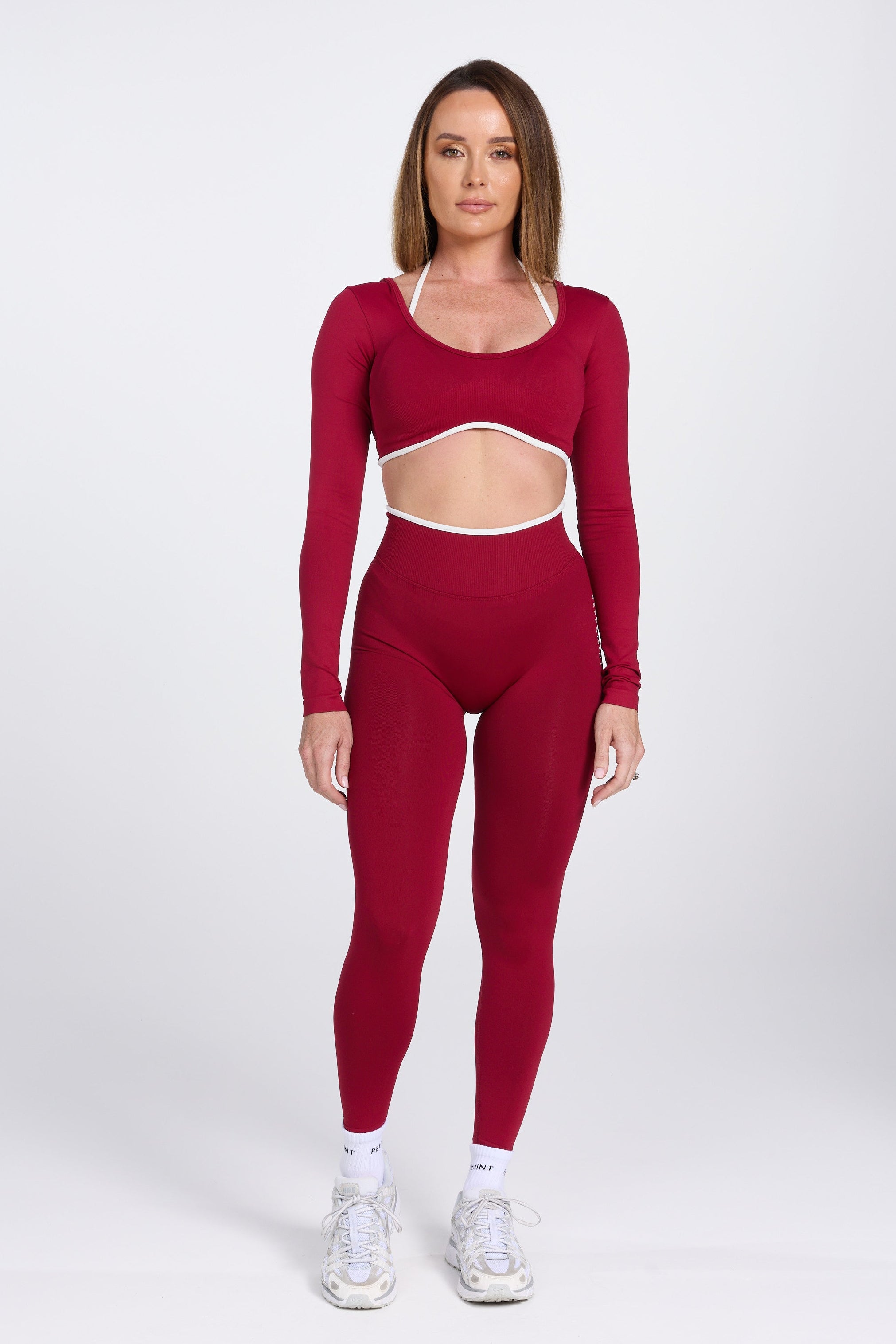 Long sleeve seamless crop top, with built in white contrasting bra, luxe white trim, and adjustable halter strap in wine colour.