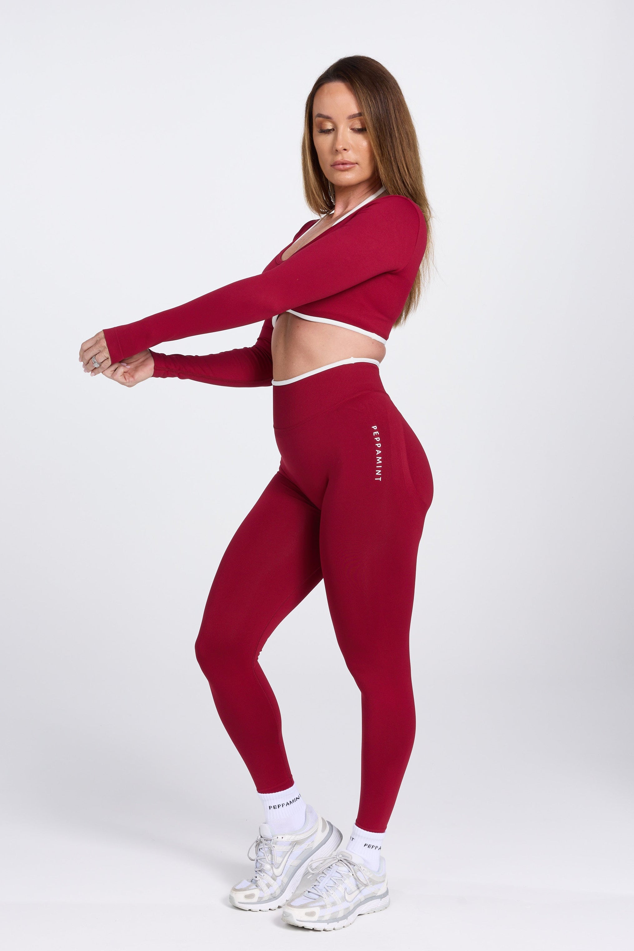 Long sleeve seamless crop top, with built in white contrasting bra, luxe white trim, and adjustable halter strap in wine colour.