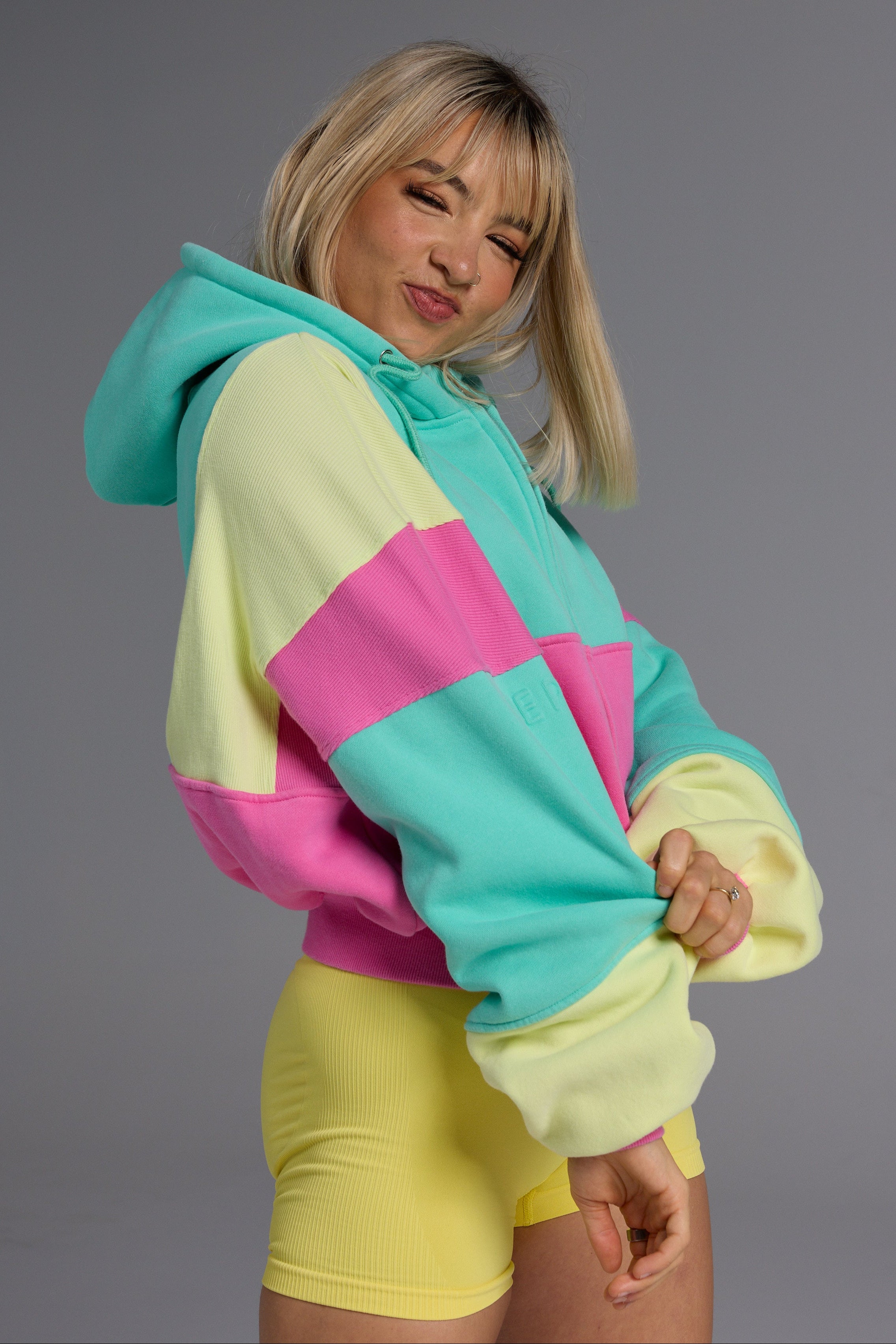Hip length, full zip hoodie, with ribbed panels, embossed sleeve logo, in a slouchy oversize fit, with 2 convenient zip pockets, in neon pink, green and yellow.
