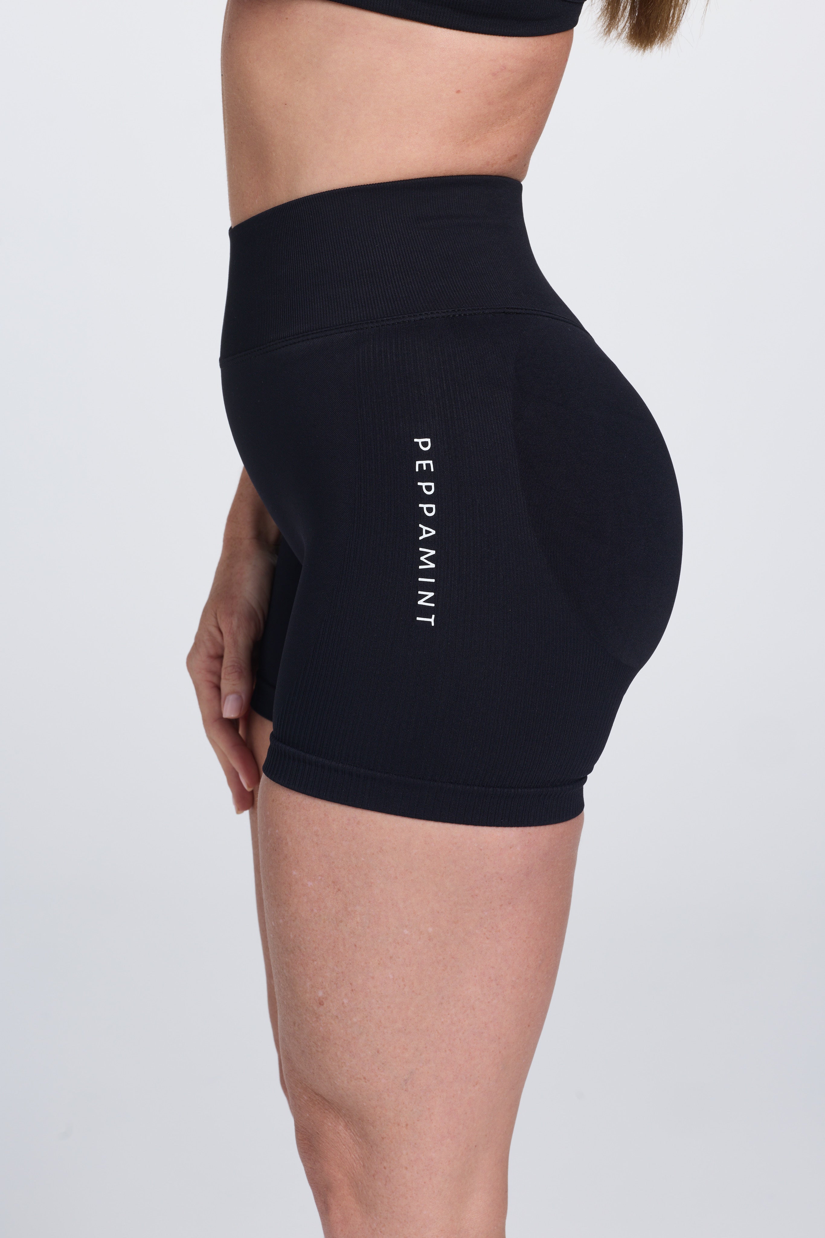 Seamless high waisted gym shorts with booty contouring panels, invisible scrunch technology, sweetheart shaped back seams and thick supportive fabric in black