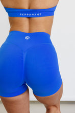 Load image into Gallery viewer, Seamless shorts with booty contouring panels, a thick supportive waistband in royal blue
