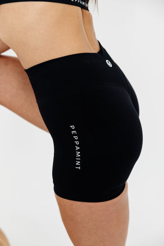 Seamless shorts with booty contouring panels, a thick supportive waistband in black