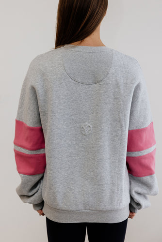 grey marl crew neck jumper with ribbed arm panels in pink with embossed logo breast cancer awareness