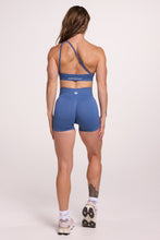 Load image into Gallery viewer, Front cross over strap activewear bra in seamless fabric with adjustable back straps, and ribbed supportive underbust band and seamless gym tights with booty contouring panels, invisible scrunch technology, sweetheart shaped back seams and thick supportive fabric in grey blue colour
