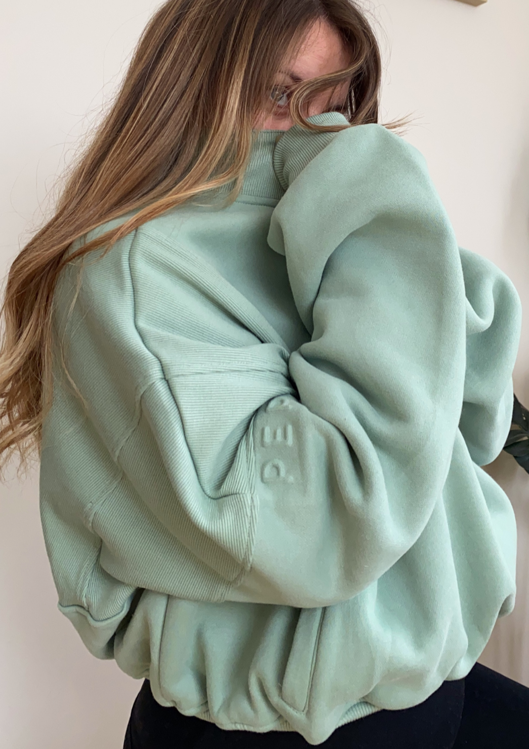 Fleece lined crop jacket in light green with half zip, and ribbed panels, and side pockets.