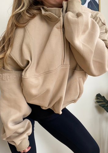 Fleece lined crop jacket in beige with half zip, and ribbed panels, and side pockets.