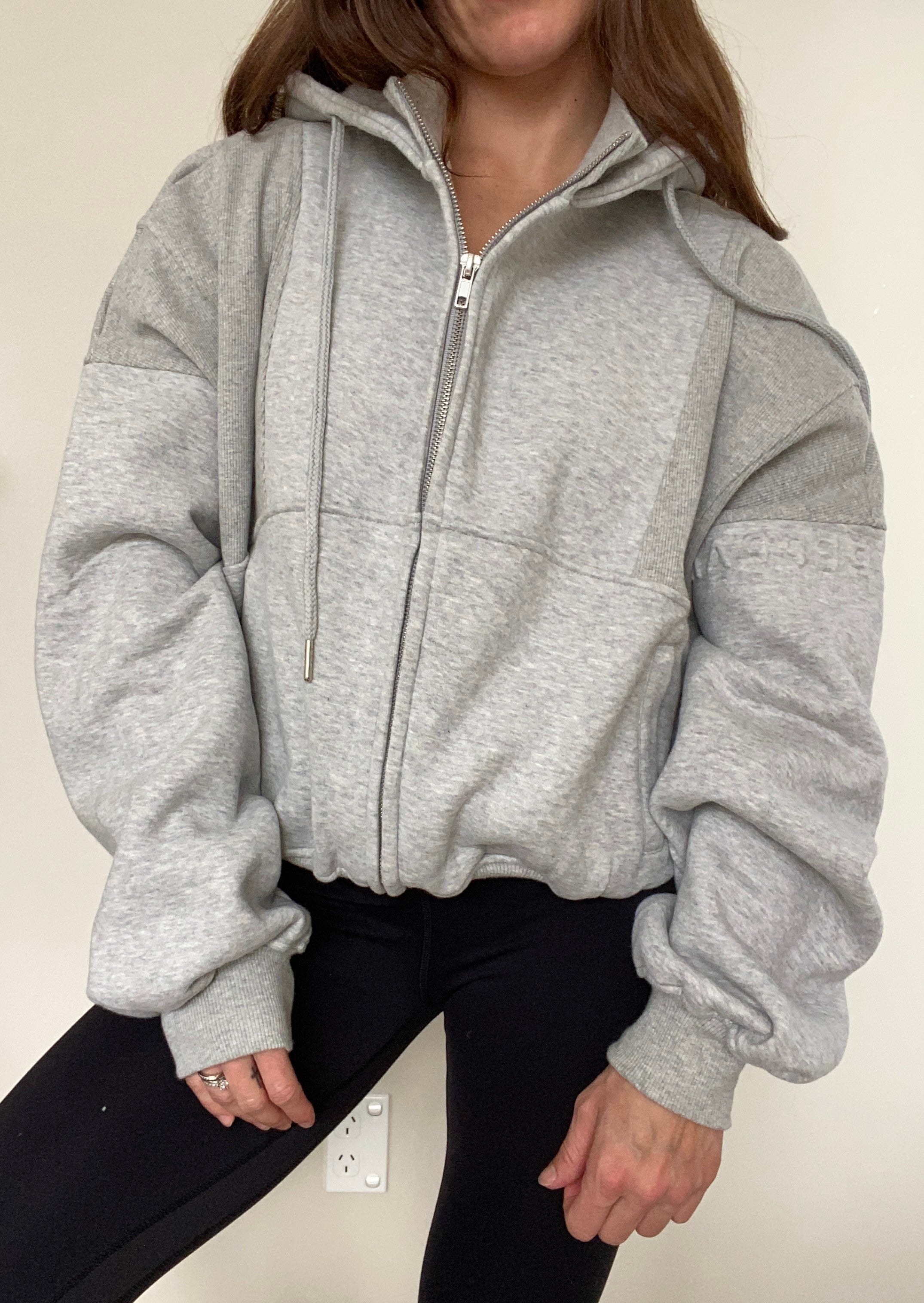 Fleece lined jacket in marl grey with full zip, hood, ribbed panels, zip pockets and embossed logo's.