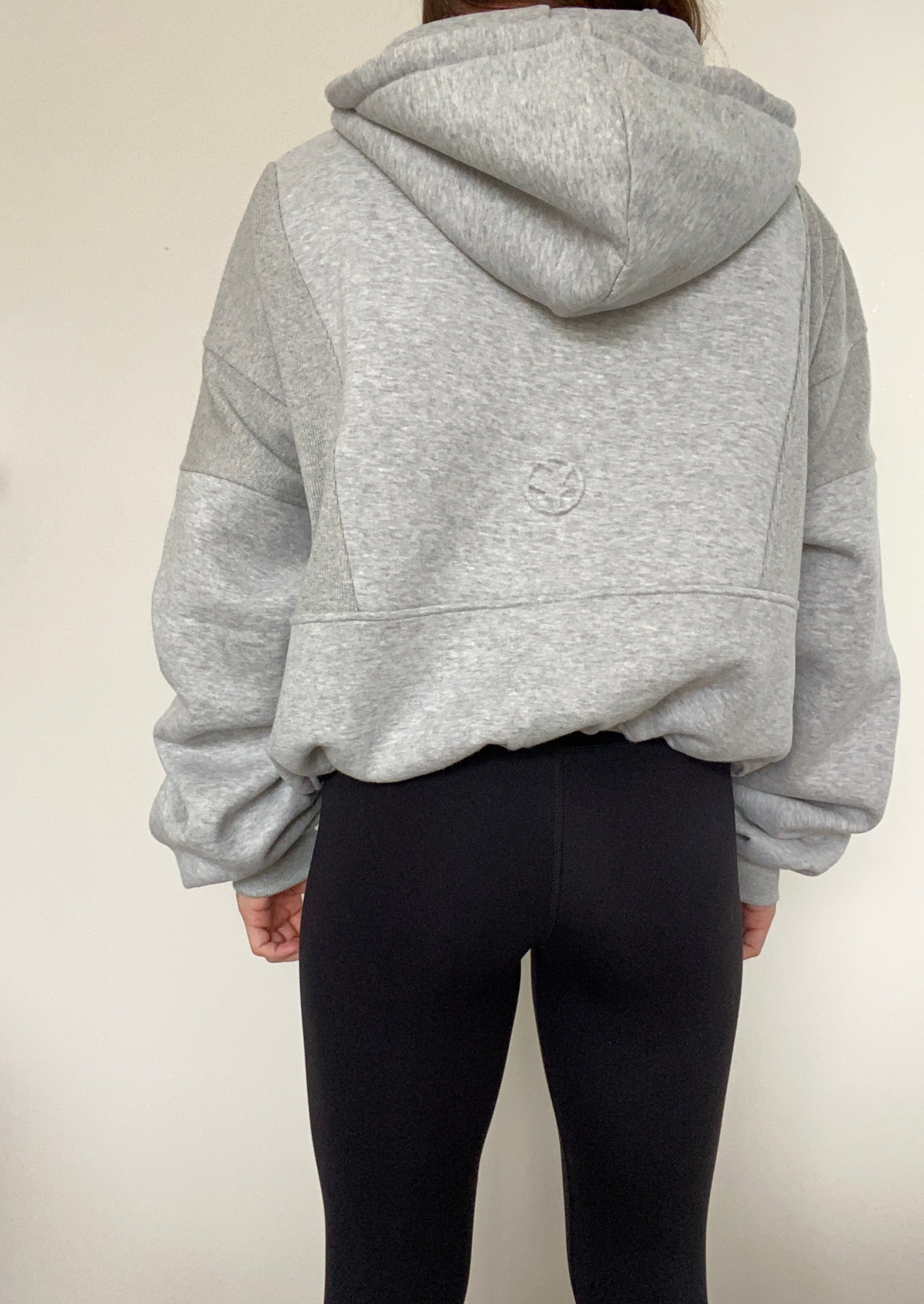 Fleece lined jacket in marl grey with full zip, hood, ribbed panels, zip pockets and embossed logo's.