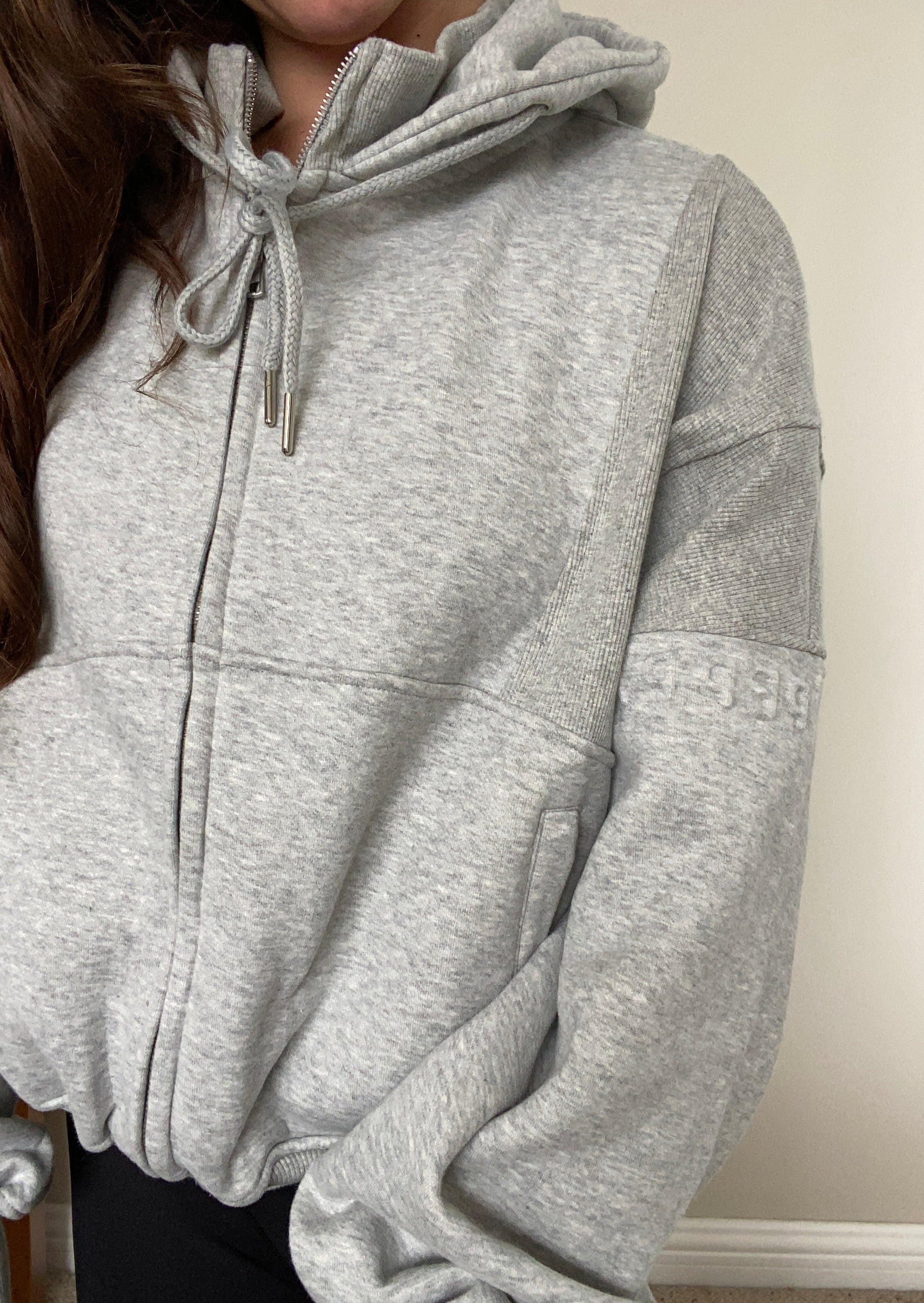 Fleece lined jacket in marl grey with full zip, hood, ribbed panels, zip pockets and embossed logo's.